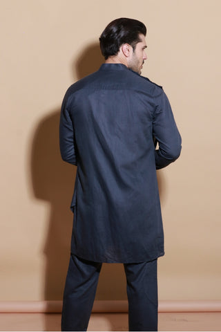 Grey short drape kurta shirt with narrow pants.