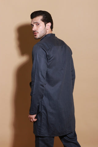 Grey short drape kurta shirt with narrow pants.