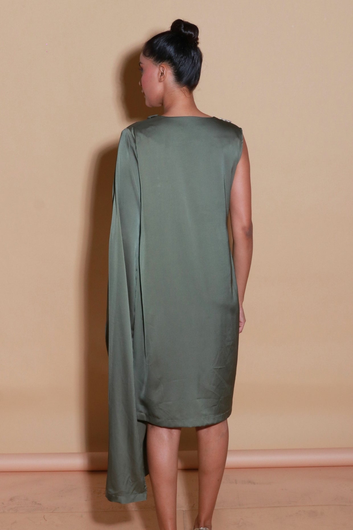 Olive green sleeveless dress with one side drape and neck embellishment.
