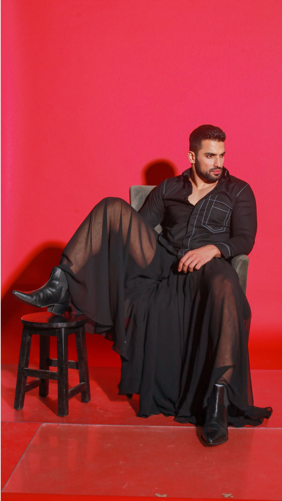 Black shirt with contrast stitching highlights.