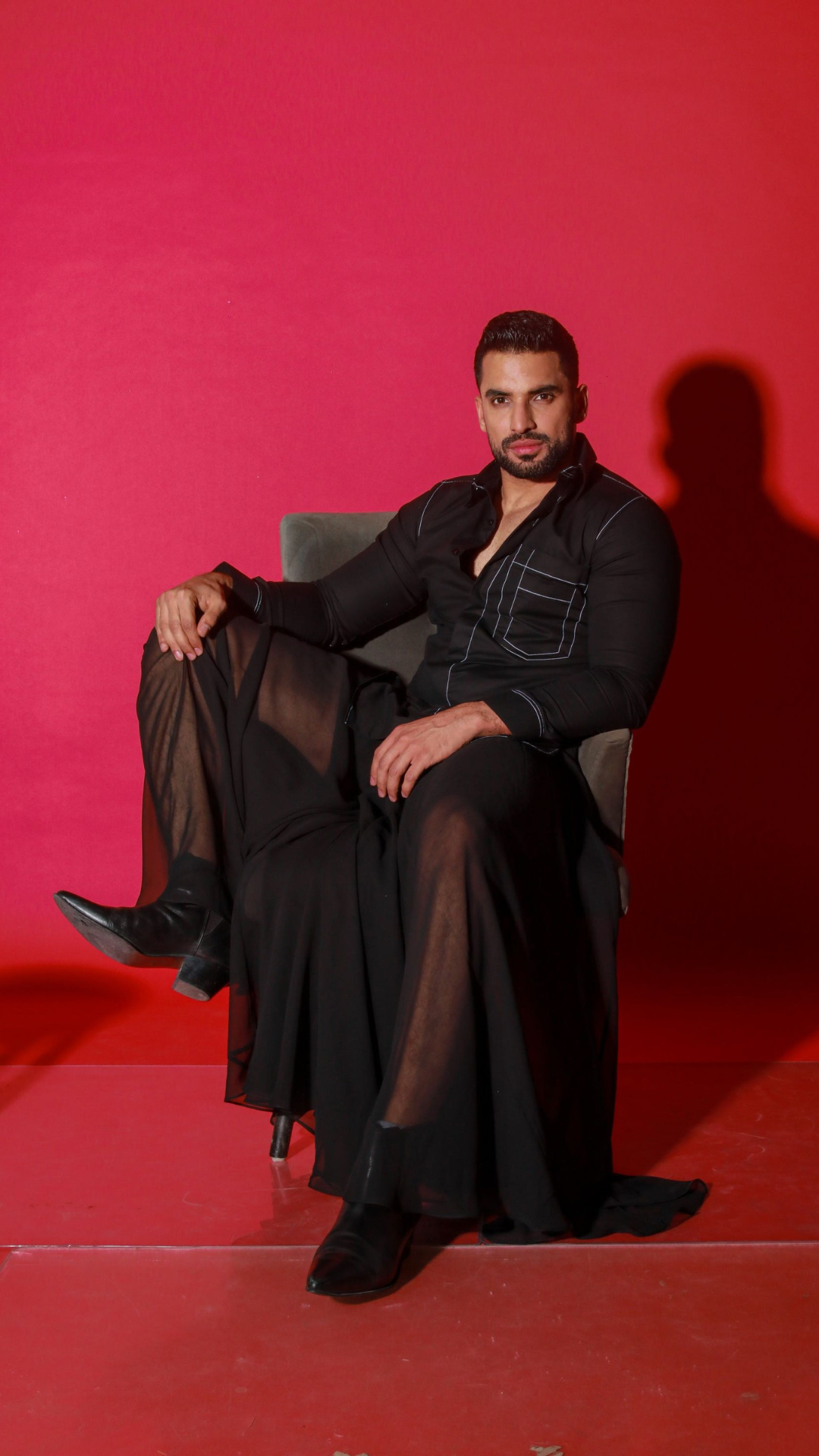 Black shirt with contrast stitching highlights.