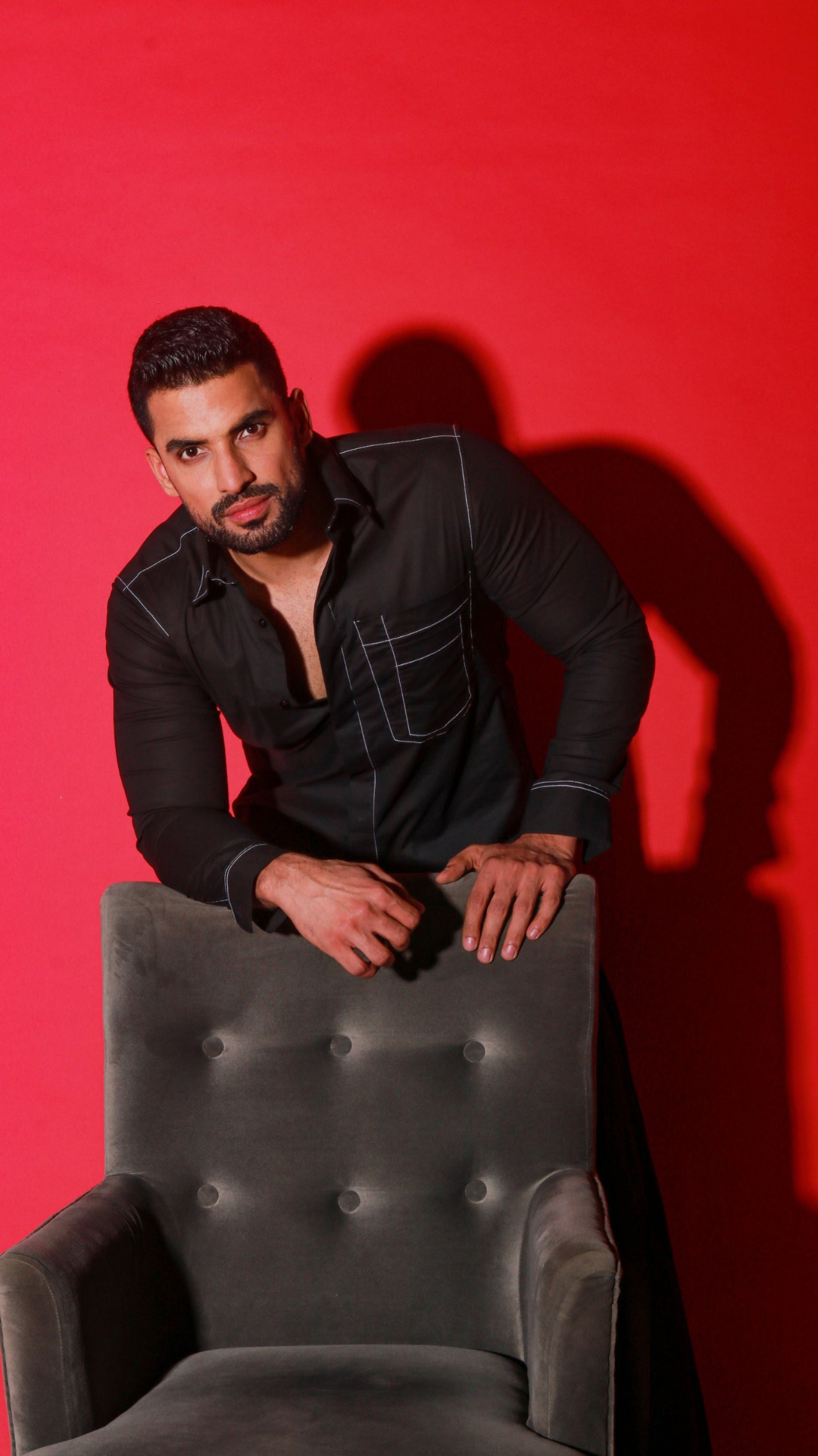 Black shirt with contrast stitching highlights.