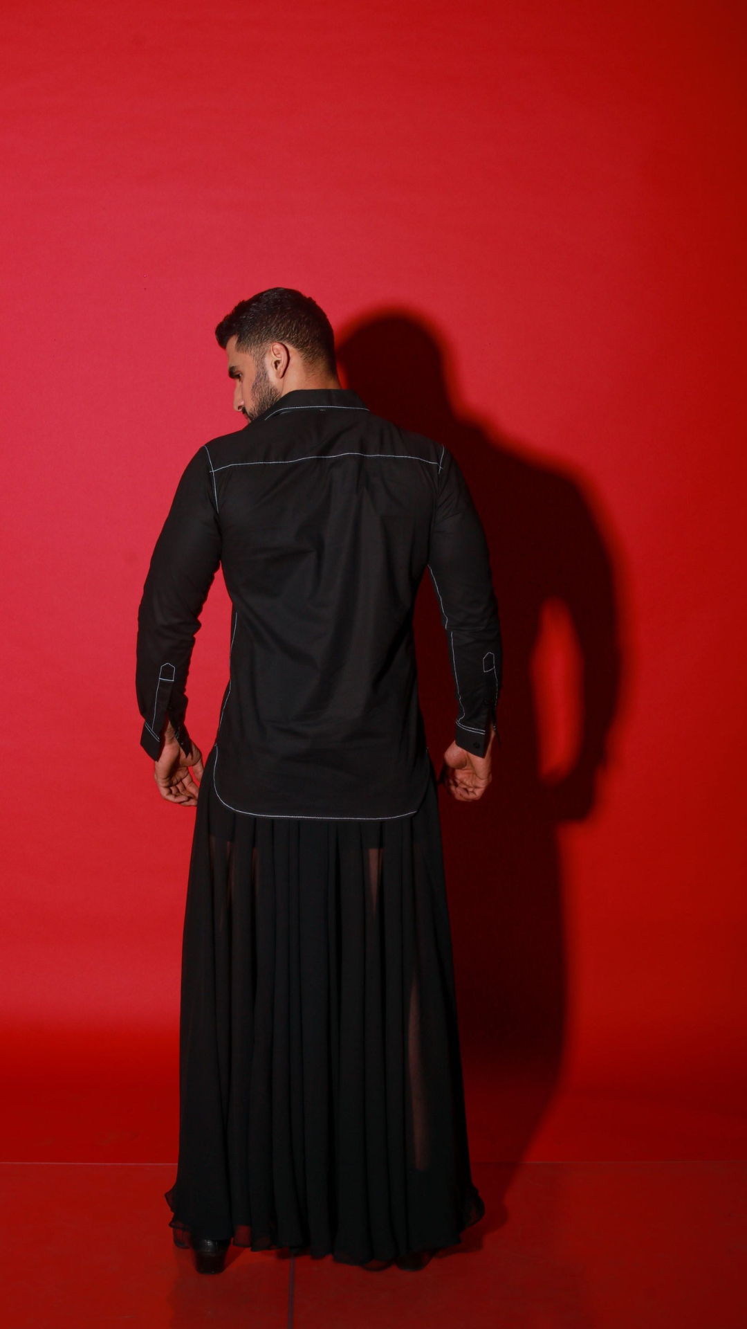 Black shirt with contrast stitching highlights.