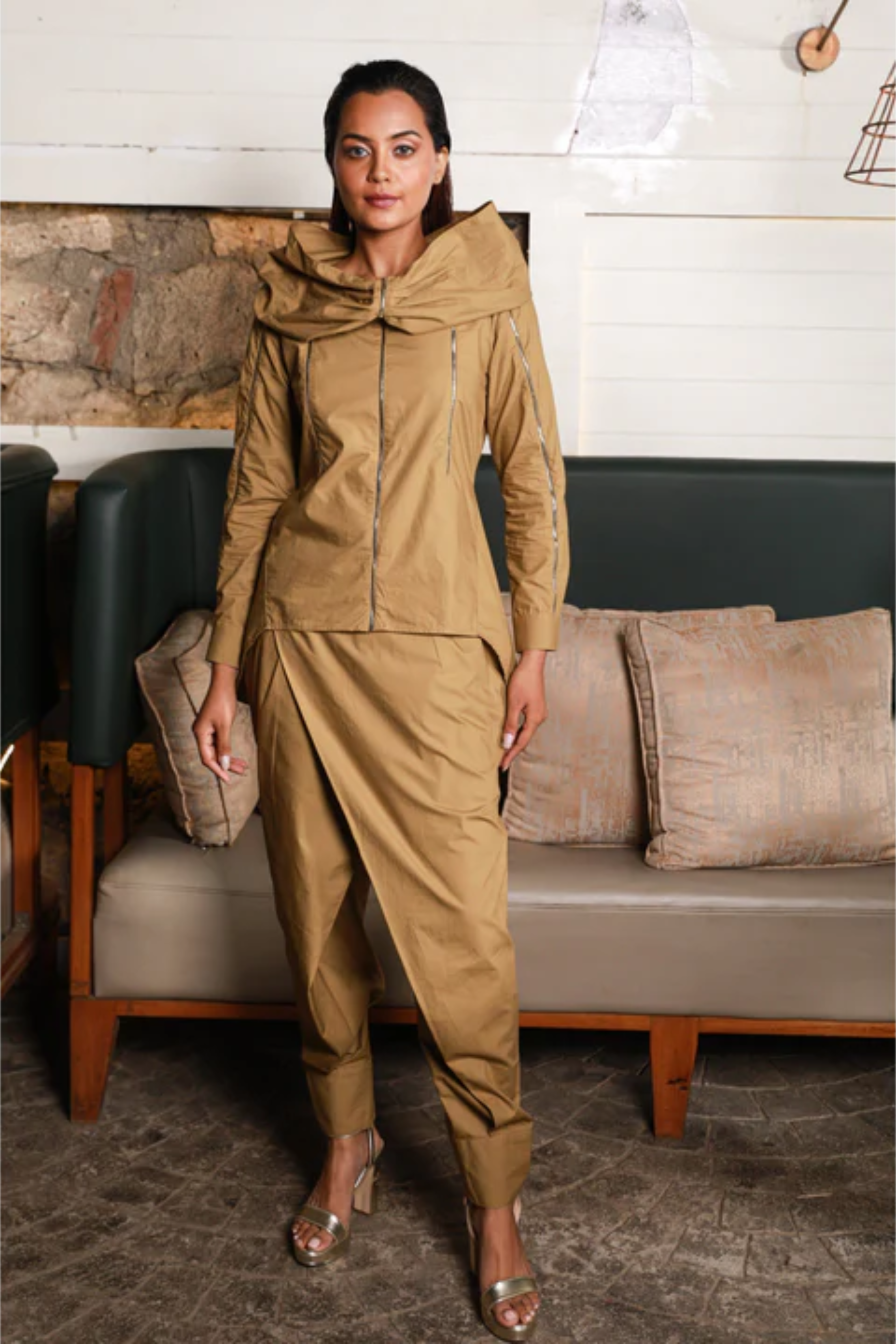 Khaki co-ord set features gold zipper detailing and cross over pants with cuffed hem.