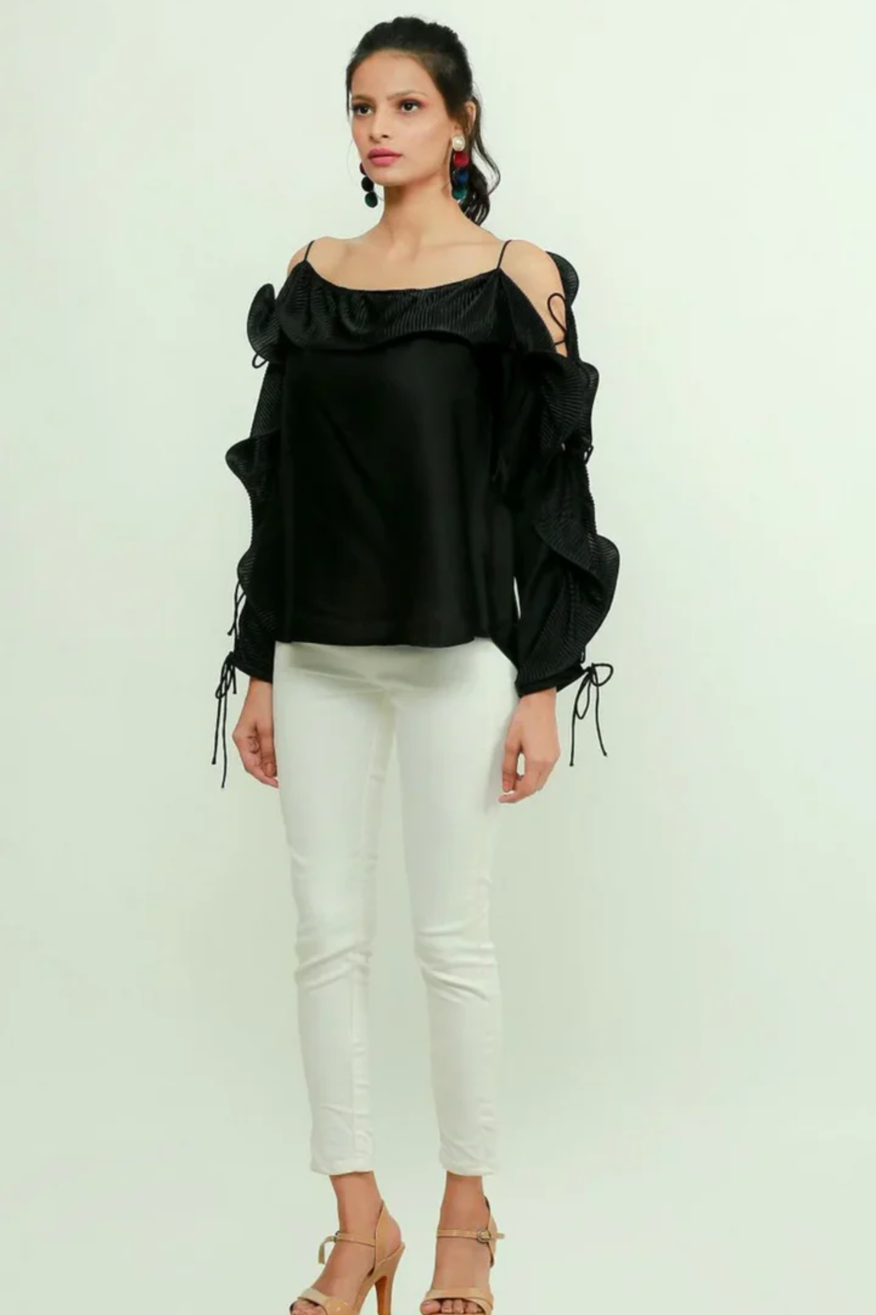 Black silk off-shoulder top features a pleated frill running across the sleeves.