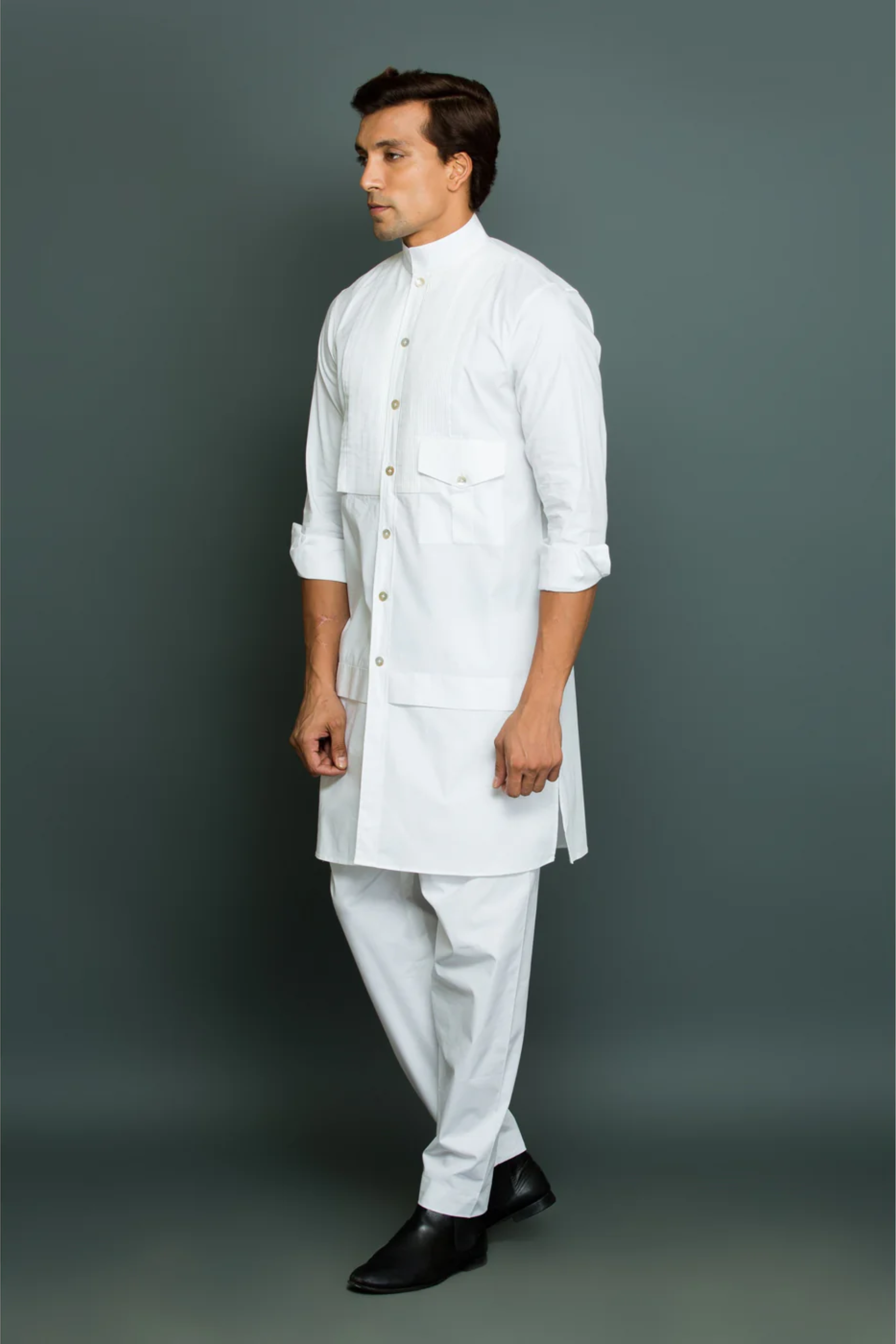 White kurta with front pleated panel and pocket with pants.