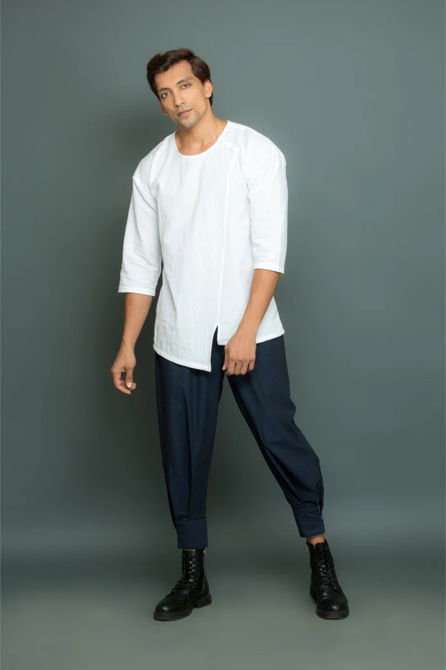 White asymmetric round neck top with cuff pants.