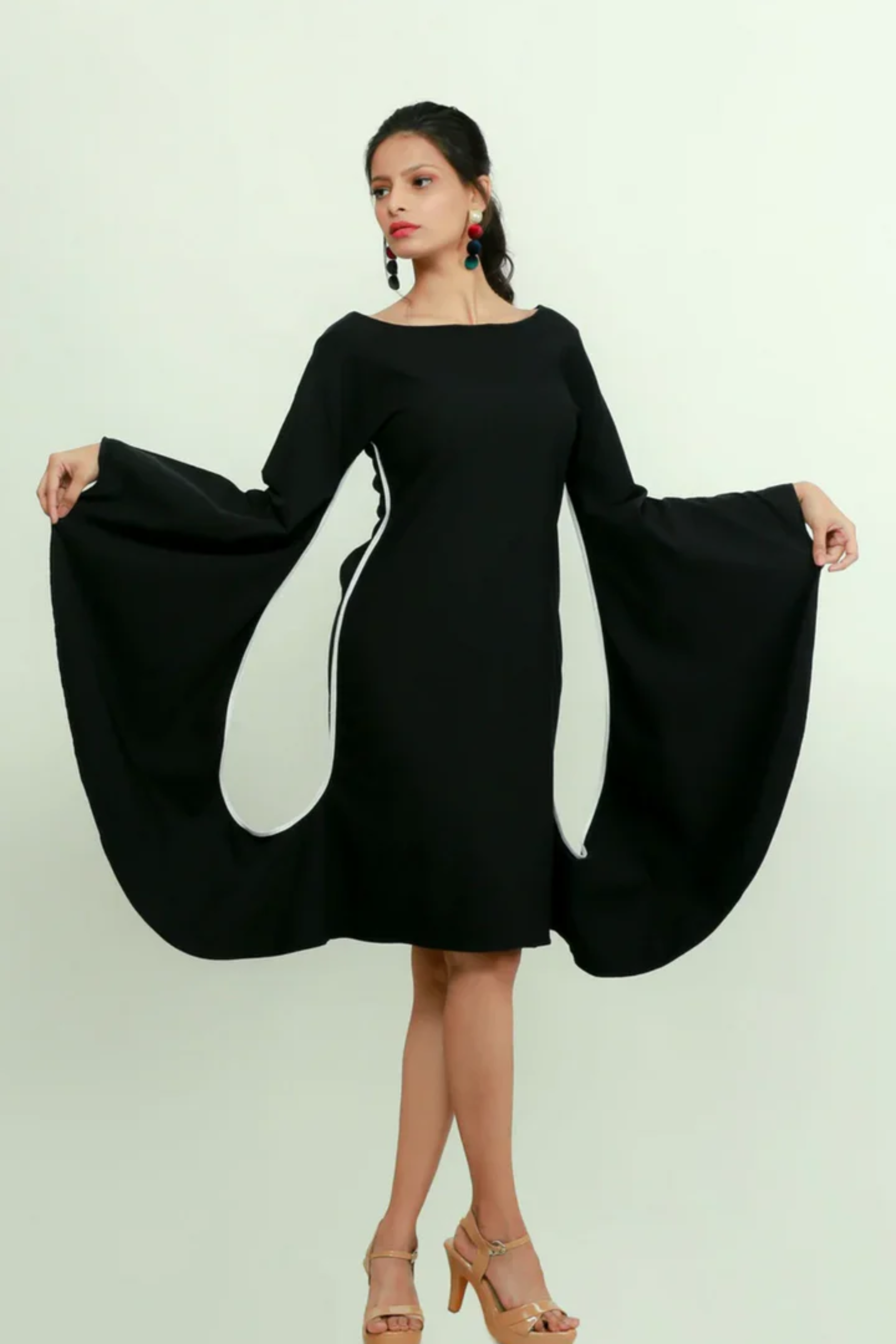 Black bodycon dress with statement sleeves.