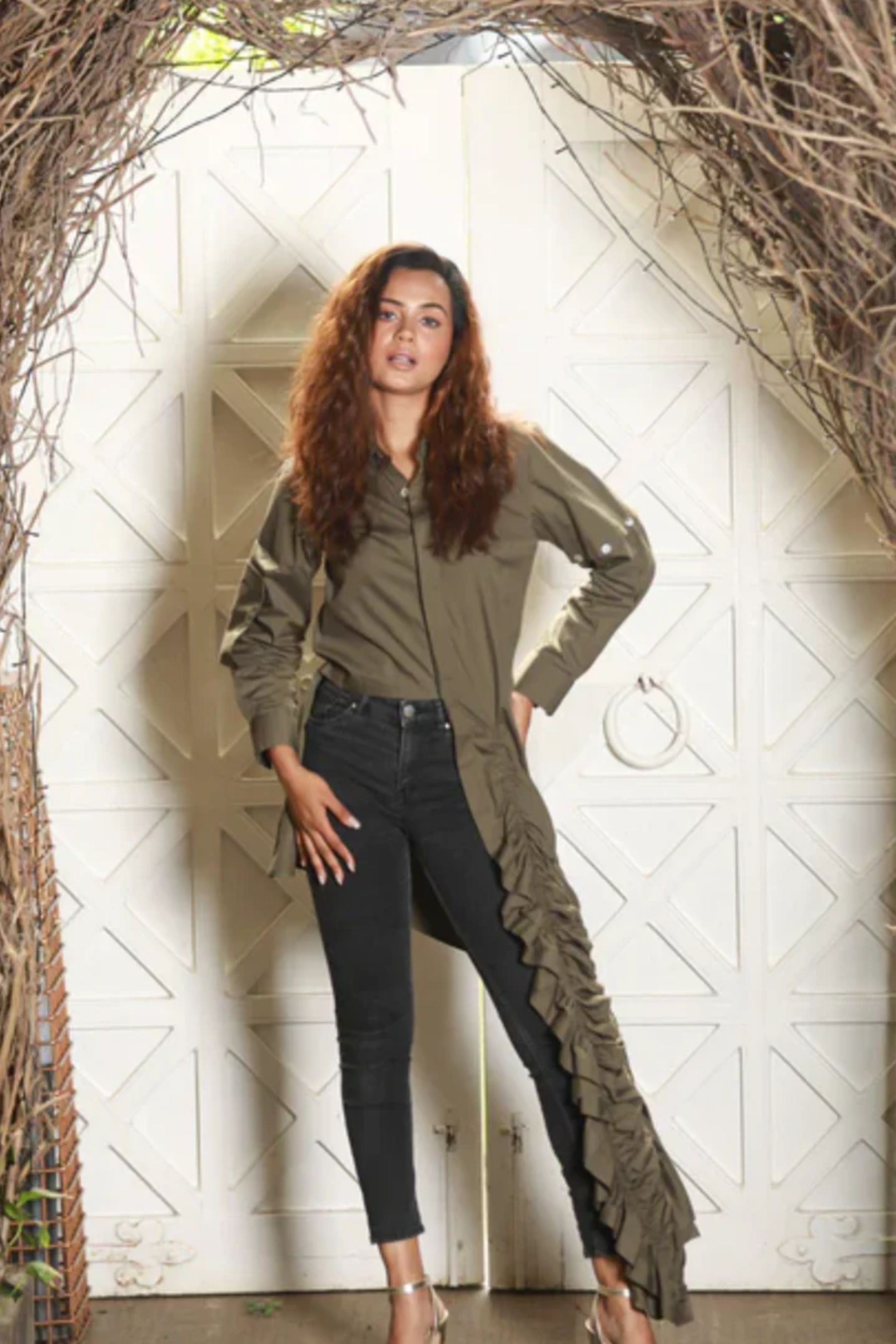 Military green cropped shirt features an extended ruched tie-up feature on one.