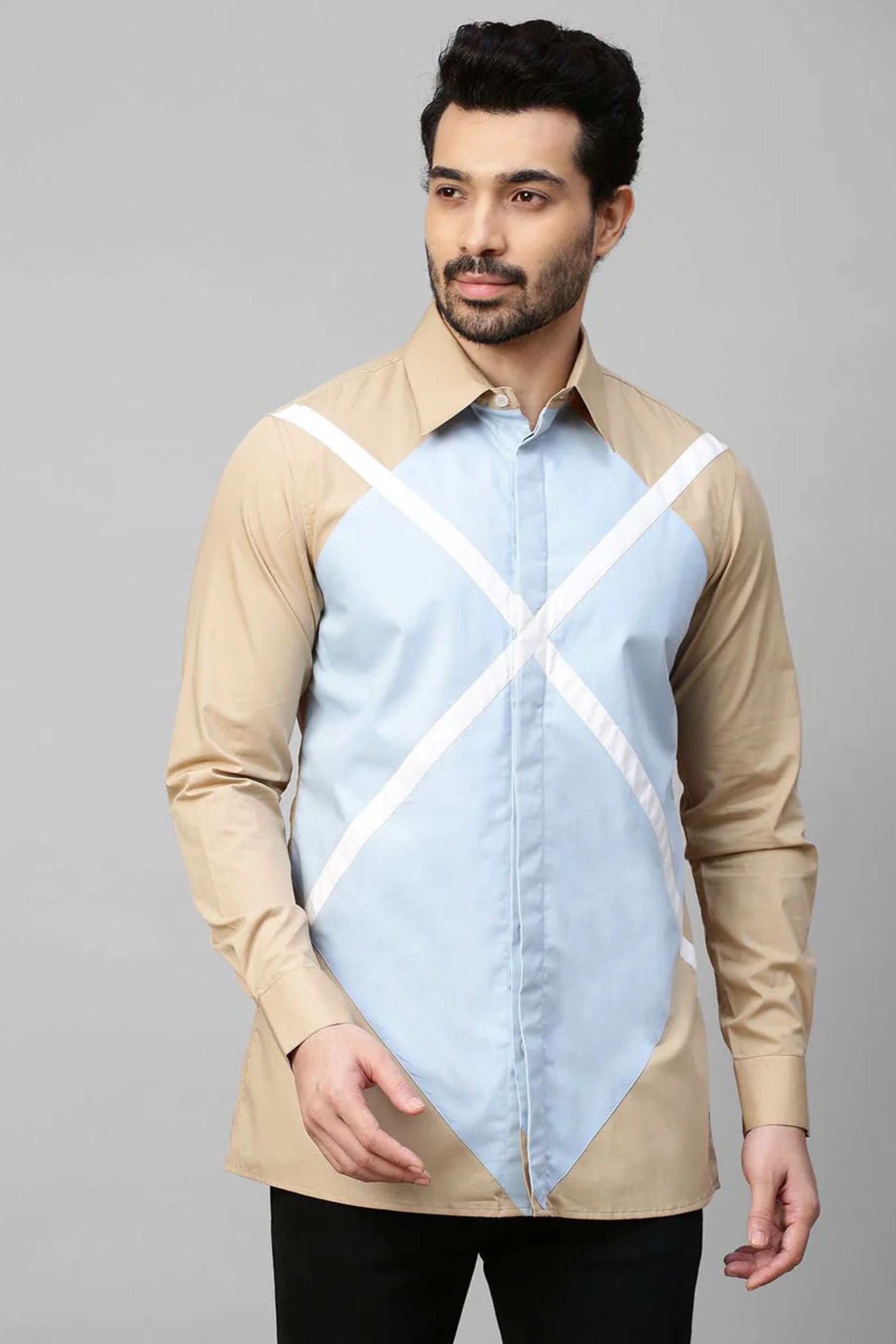 Beige shirt with light blue and white patchwork detailing.