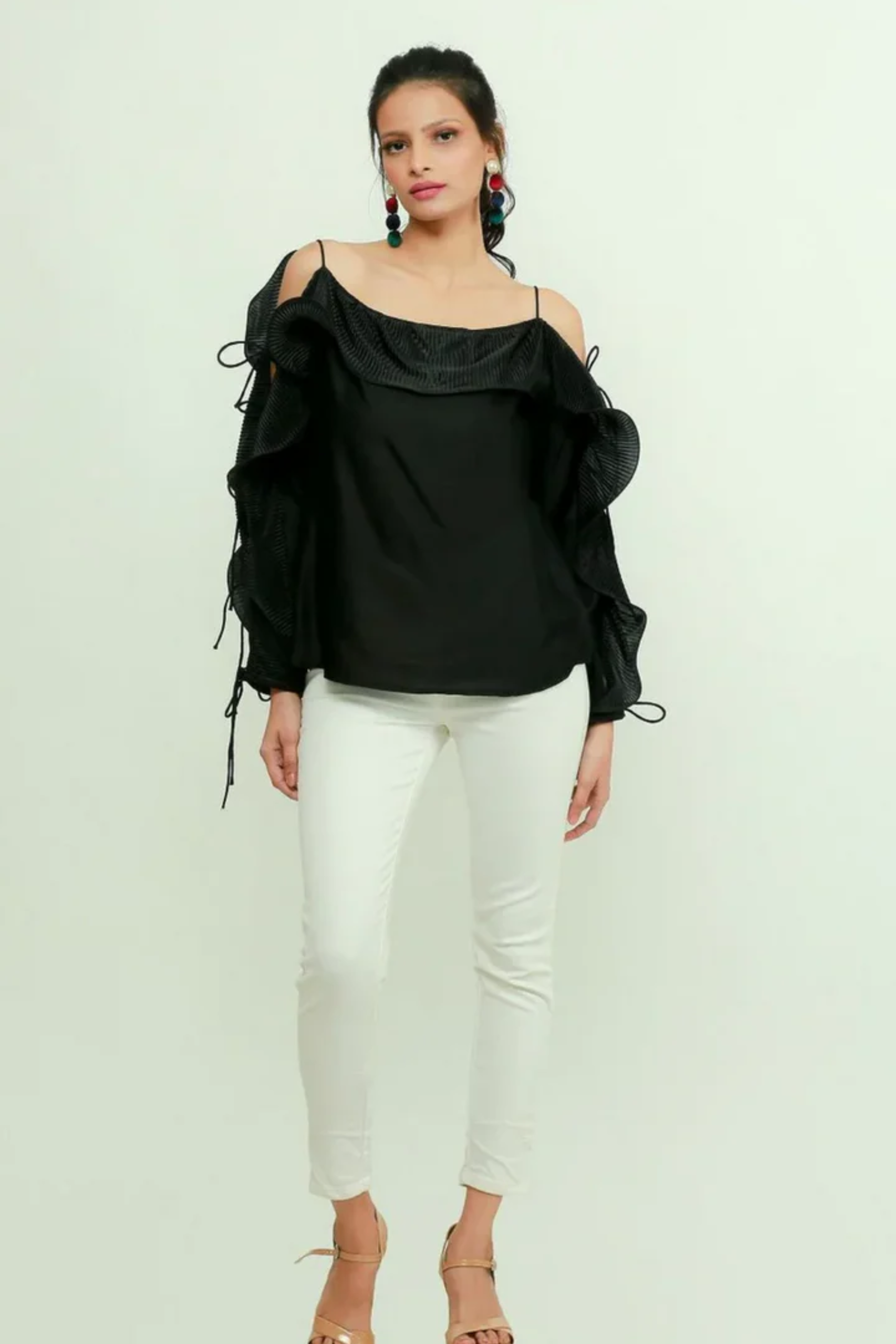 Black silk off-shoulder top features a pleated frill running across the sleeves.