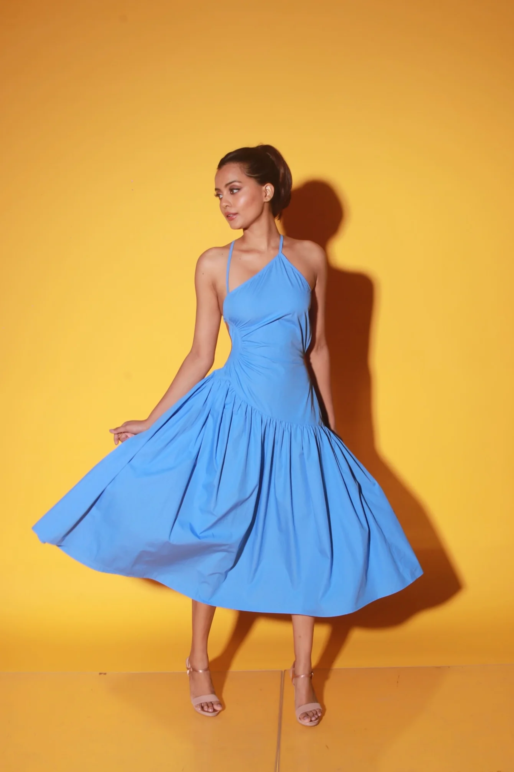 Slate blue midi dress with spaghetti straps and ruching detailing on the waist.