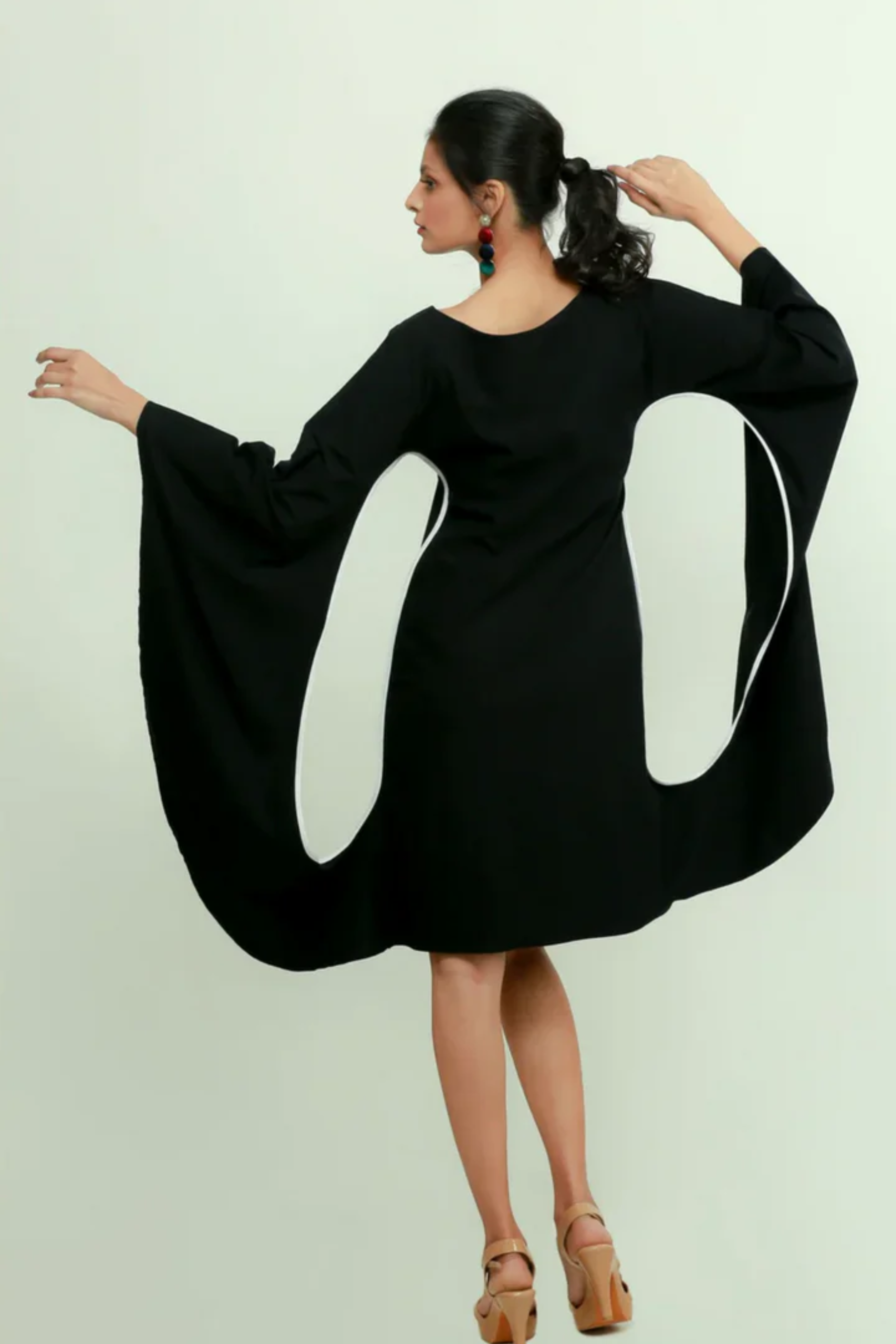 Black bodycon dress with statement sleeves.