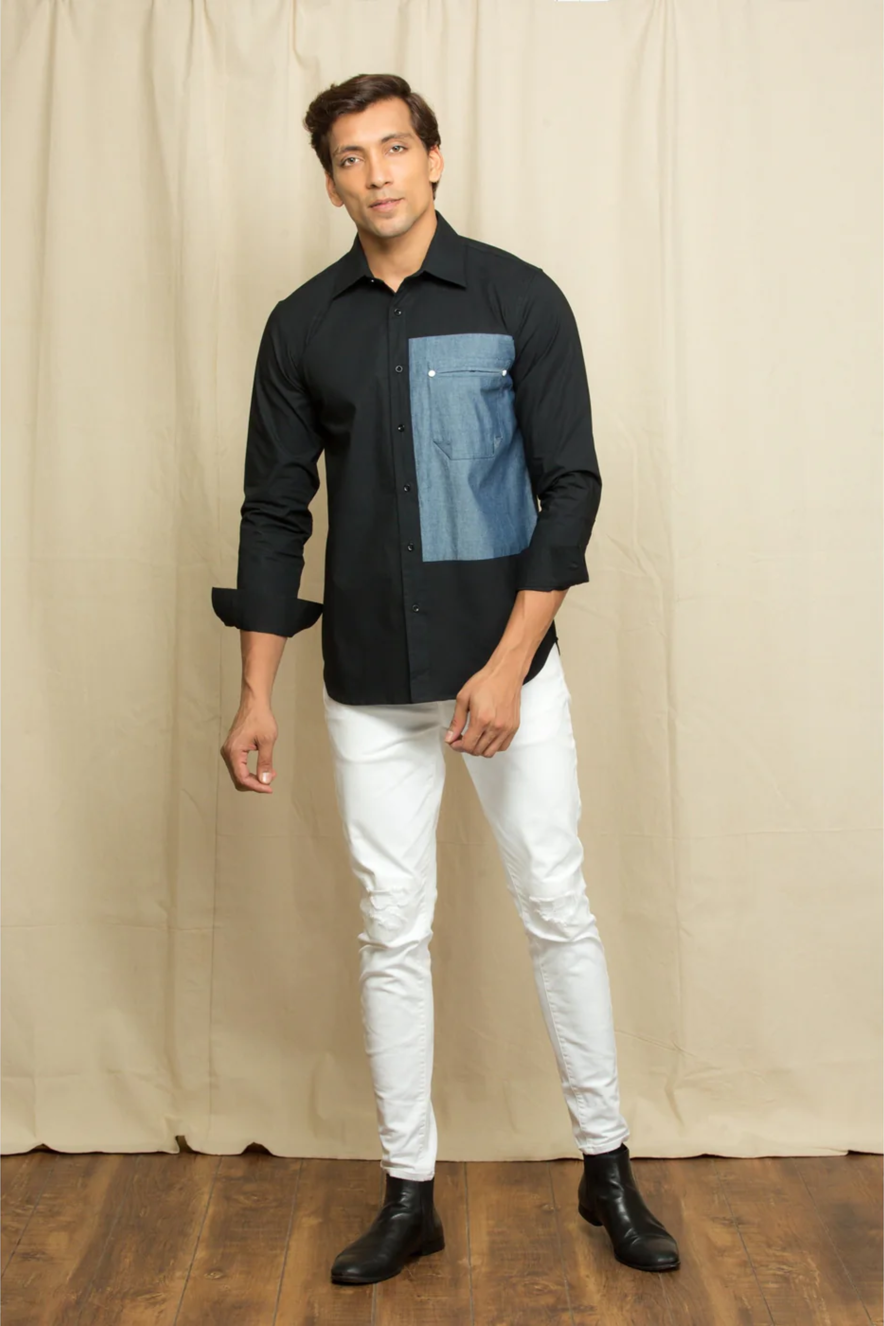 Black shirt with elongated denim patch feature.