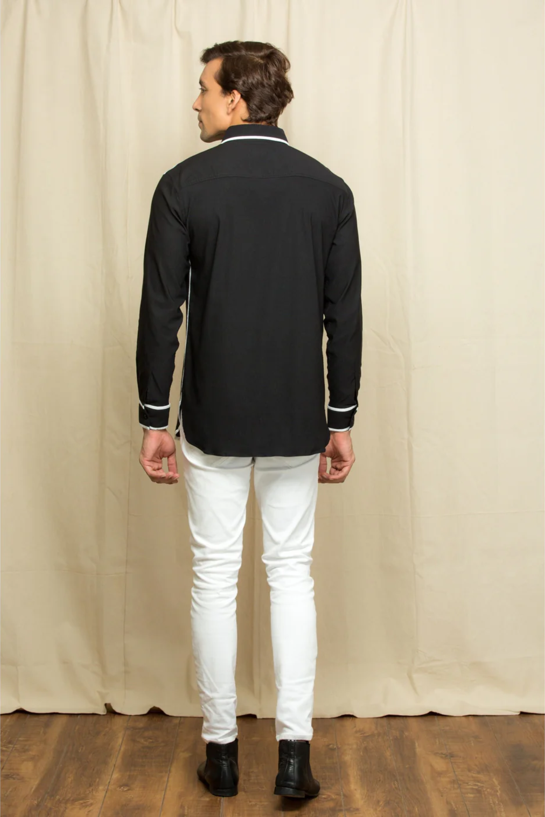 Classic black shirt with contrast white piping details.