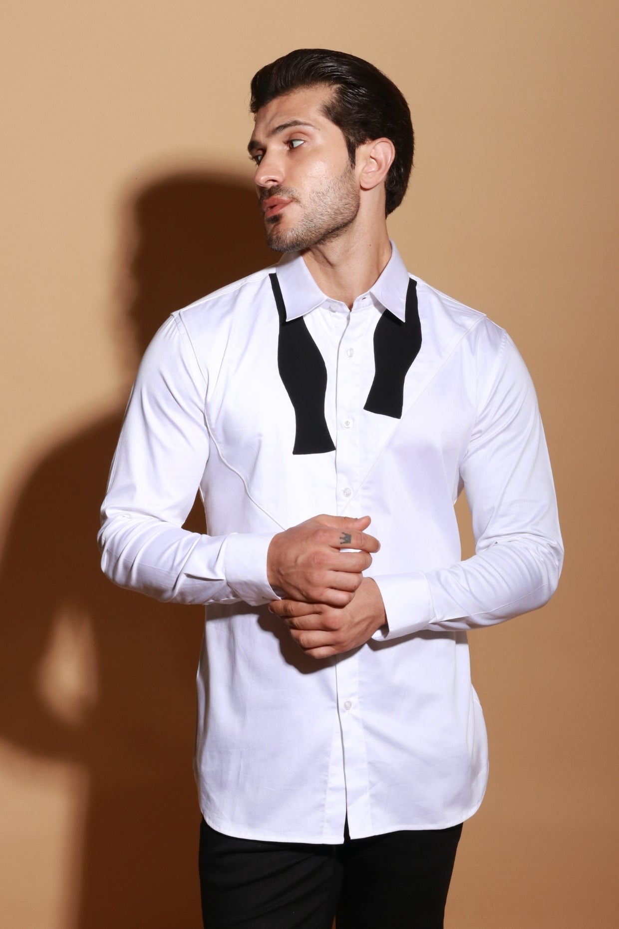 Classic white shirt with open bow design patch detailing.