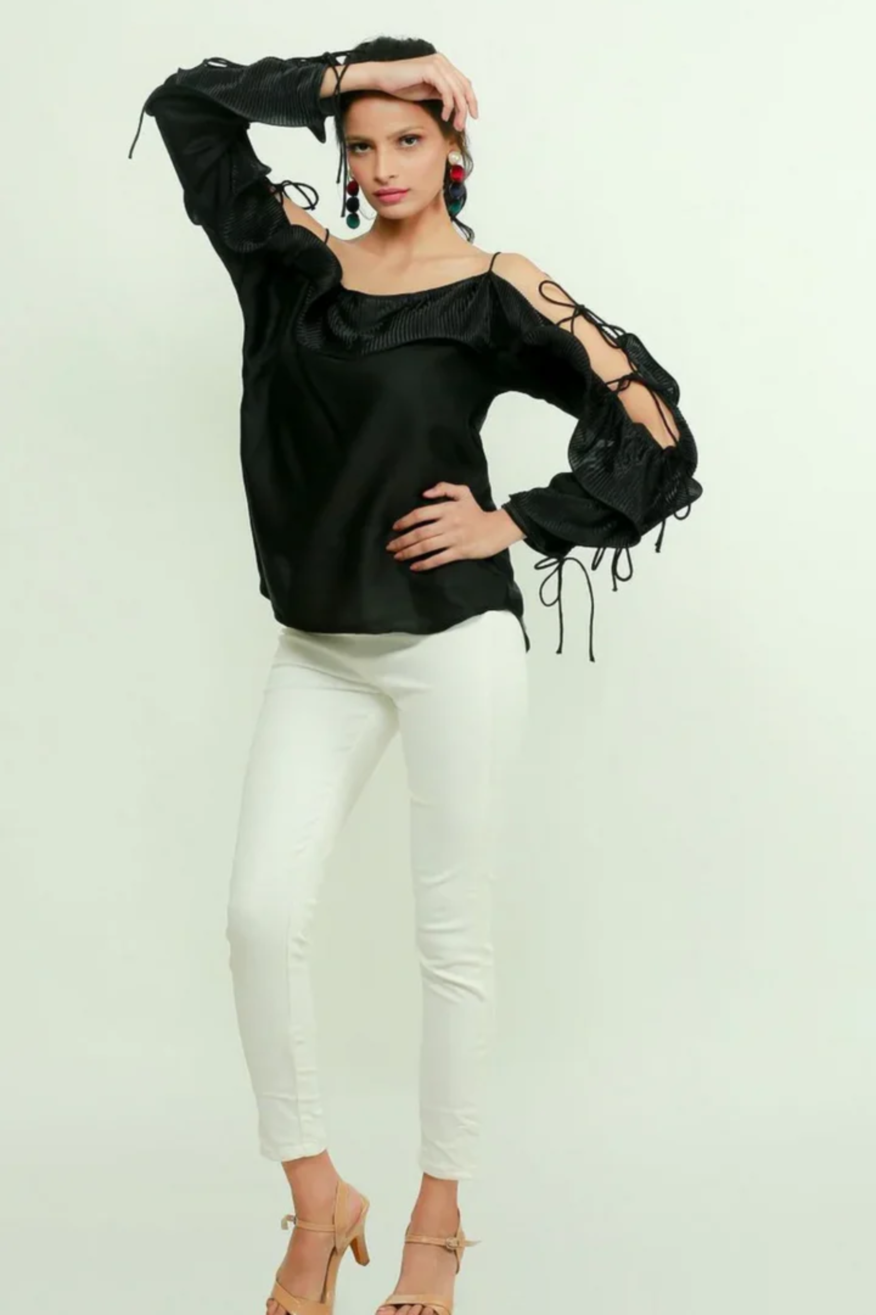 Black silk off-shoulder top features a pleated frill running across the sleeves.