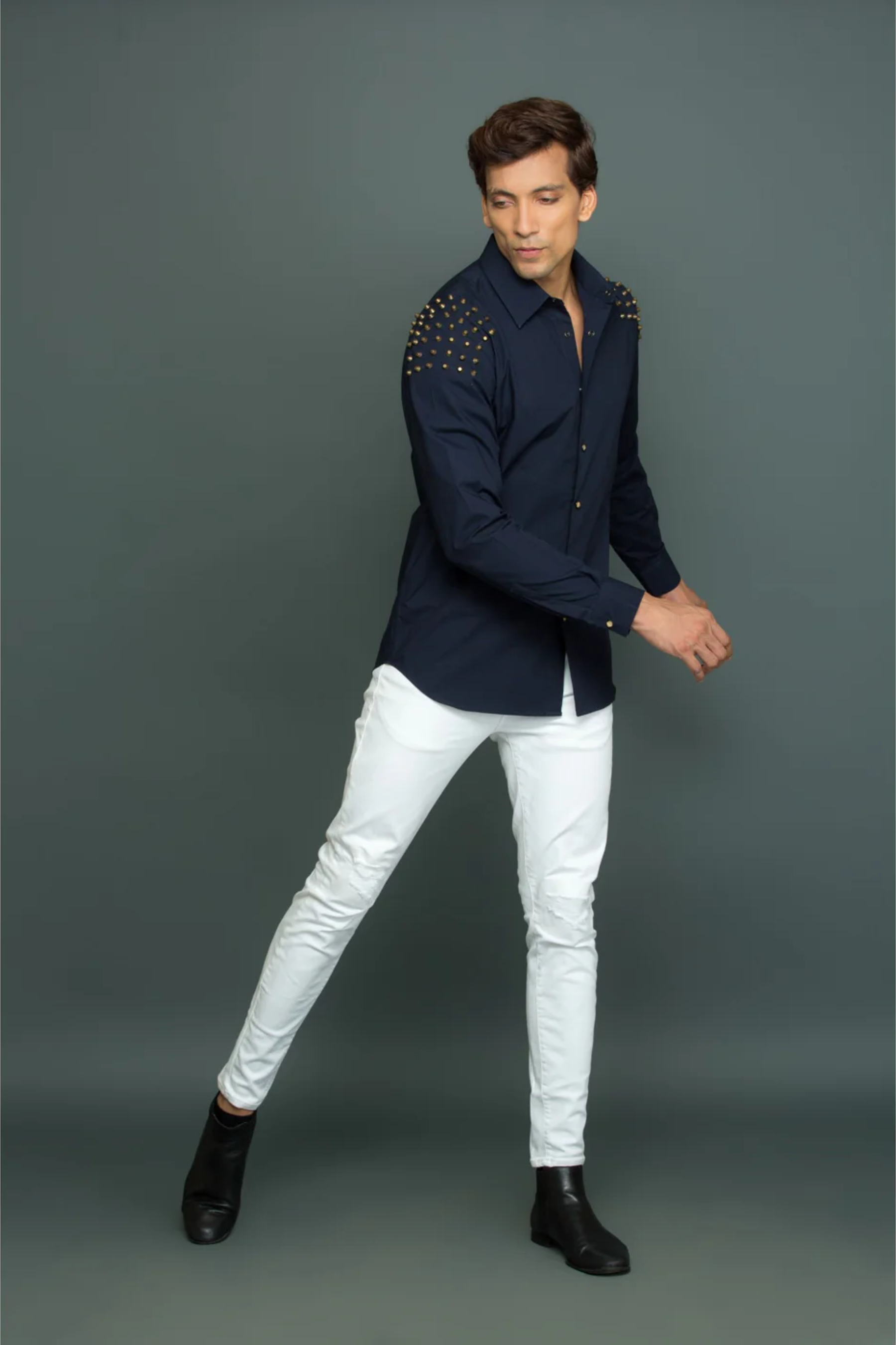 Blue shirt with shoulder rivet feature.