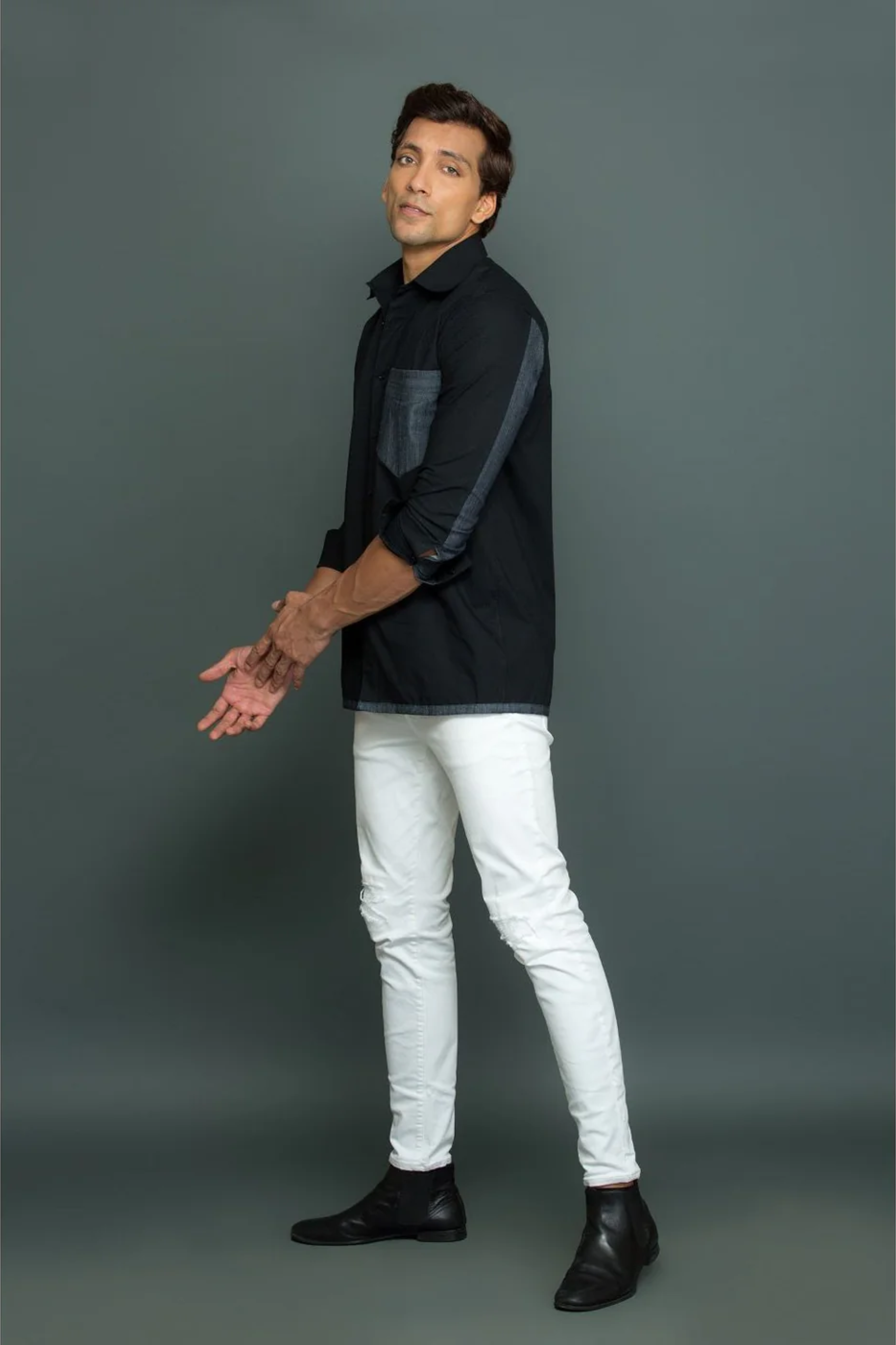 Black shirt with grey denim patch detailing.