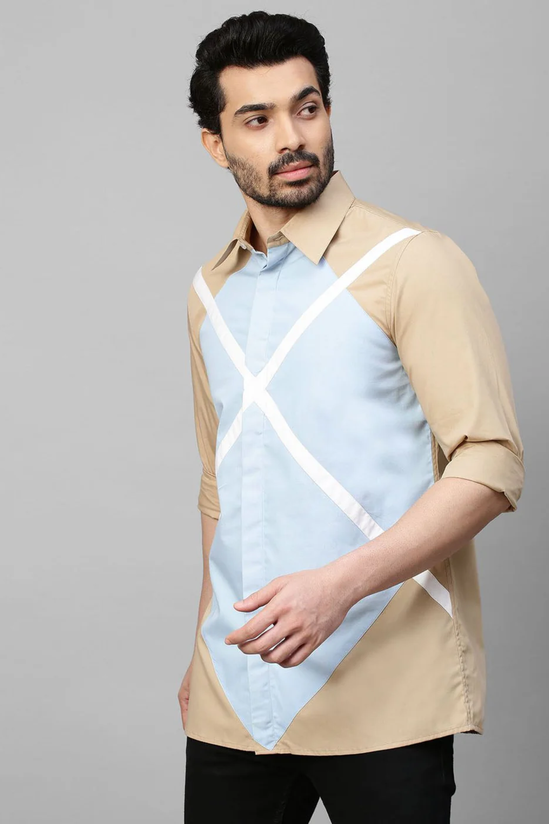 Beige shirt with light blue and white patchwork detailing.