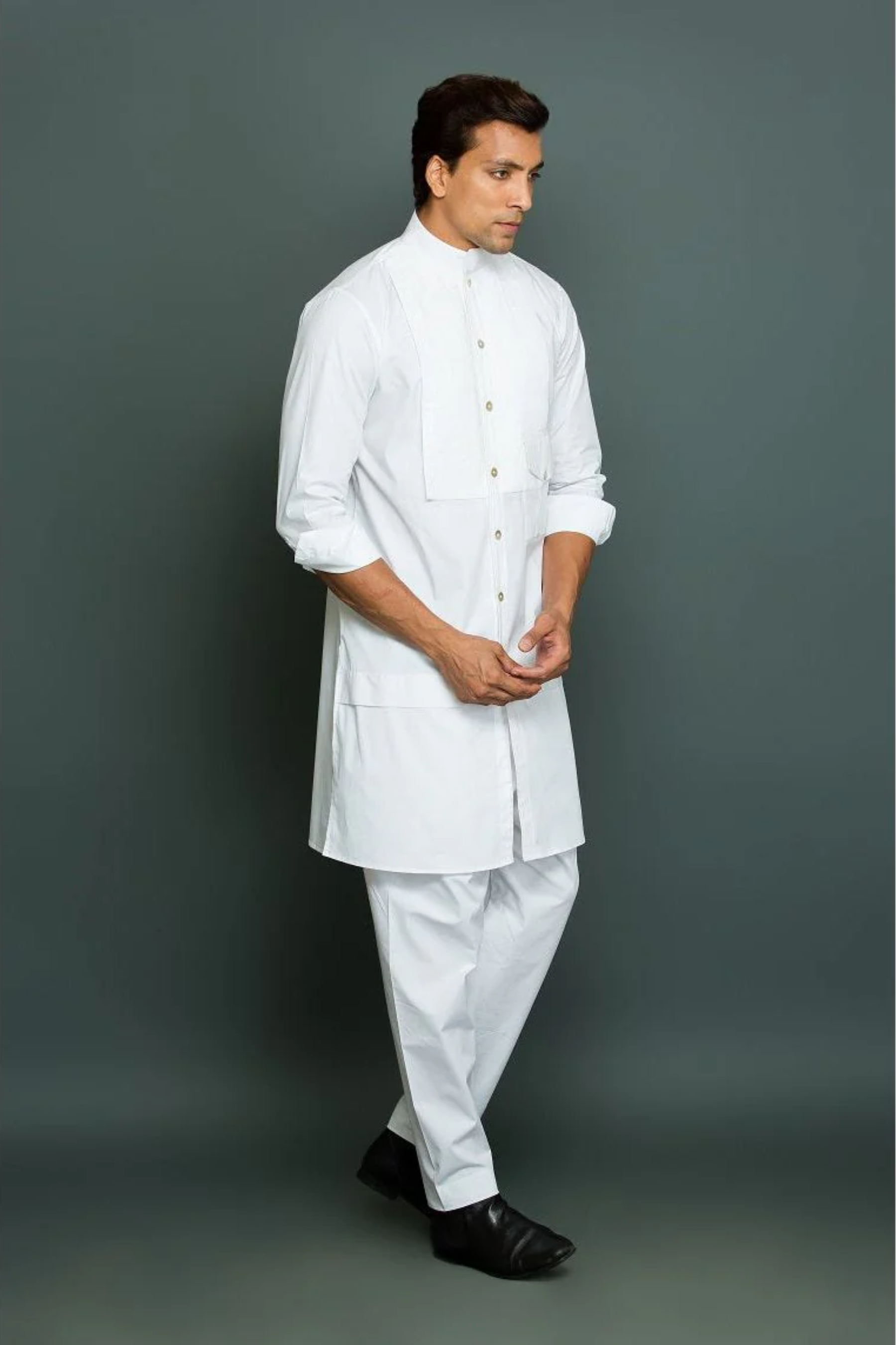 White kurta with front pleated panel and pocket with pants.