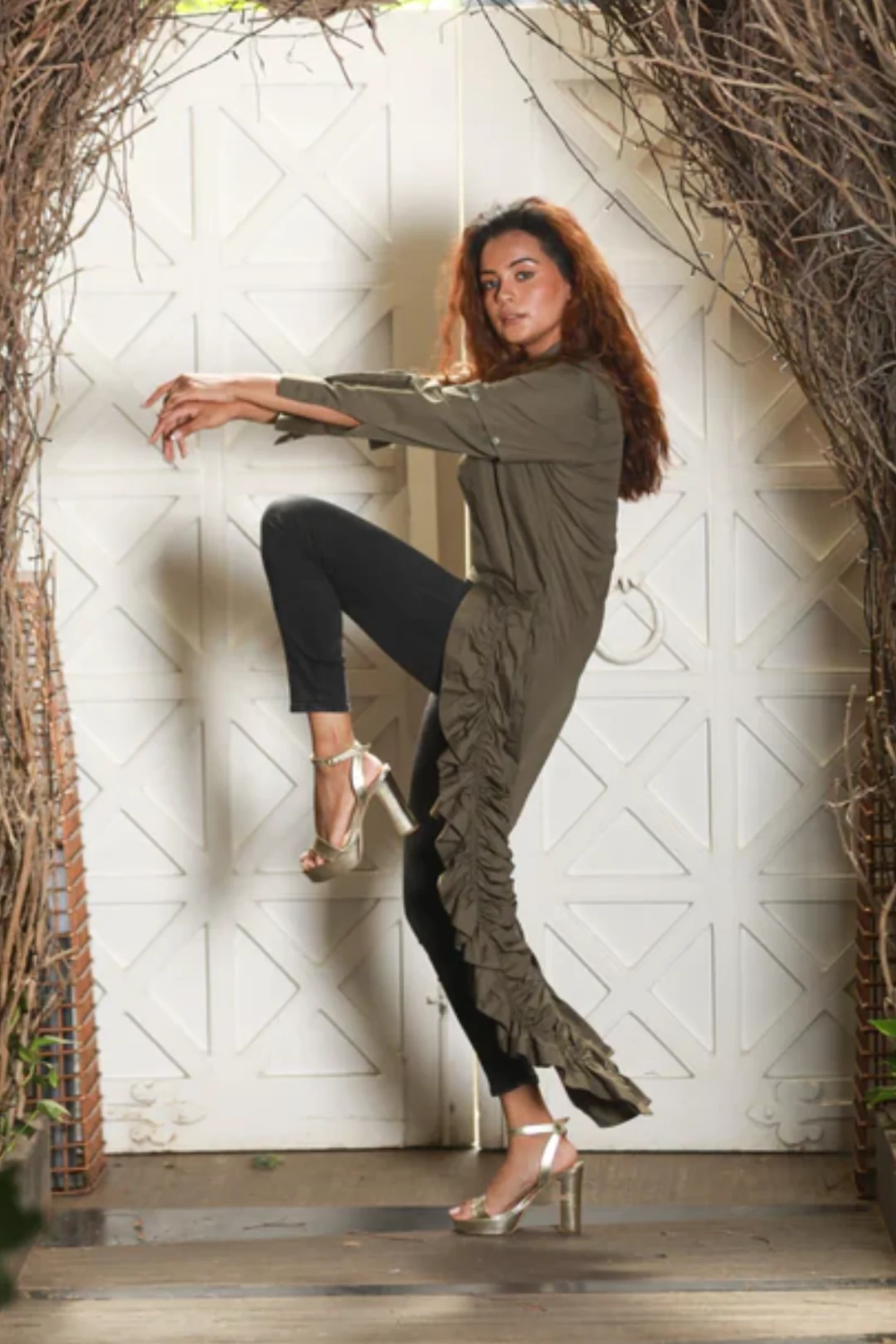 Military green cropped shirt features an extended ruched tie-up feature on one.