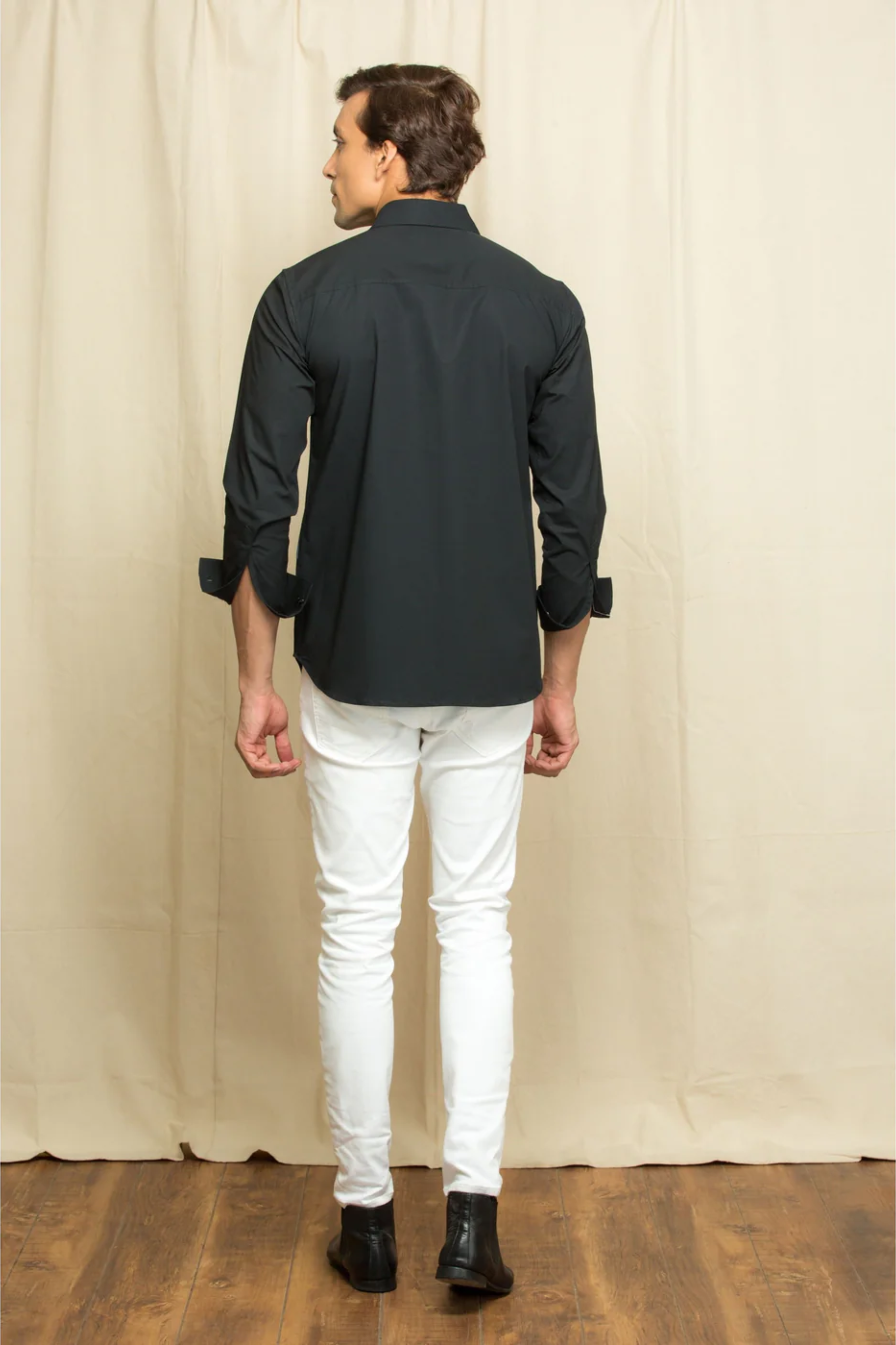 Black shirt with elongated denim patch feature.