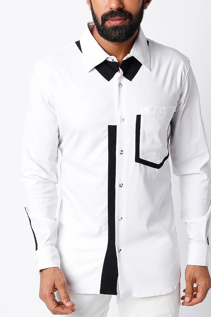 White shirt with black detailing below the collar, on placket, pocket and cuff slit