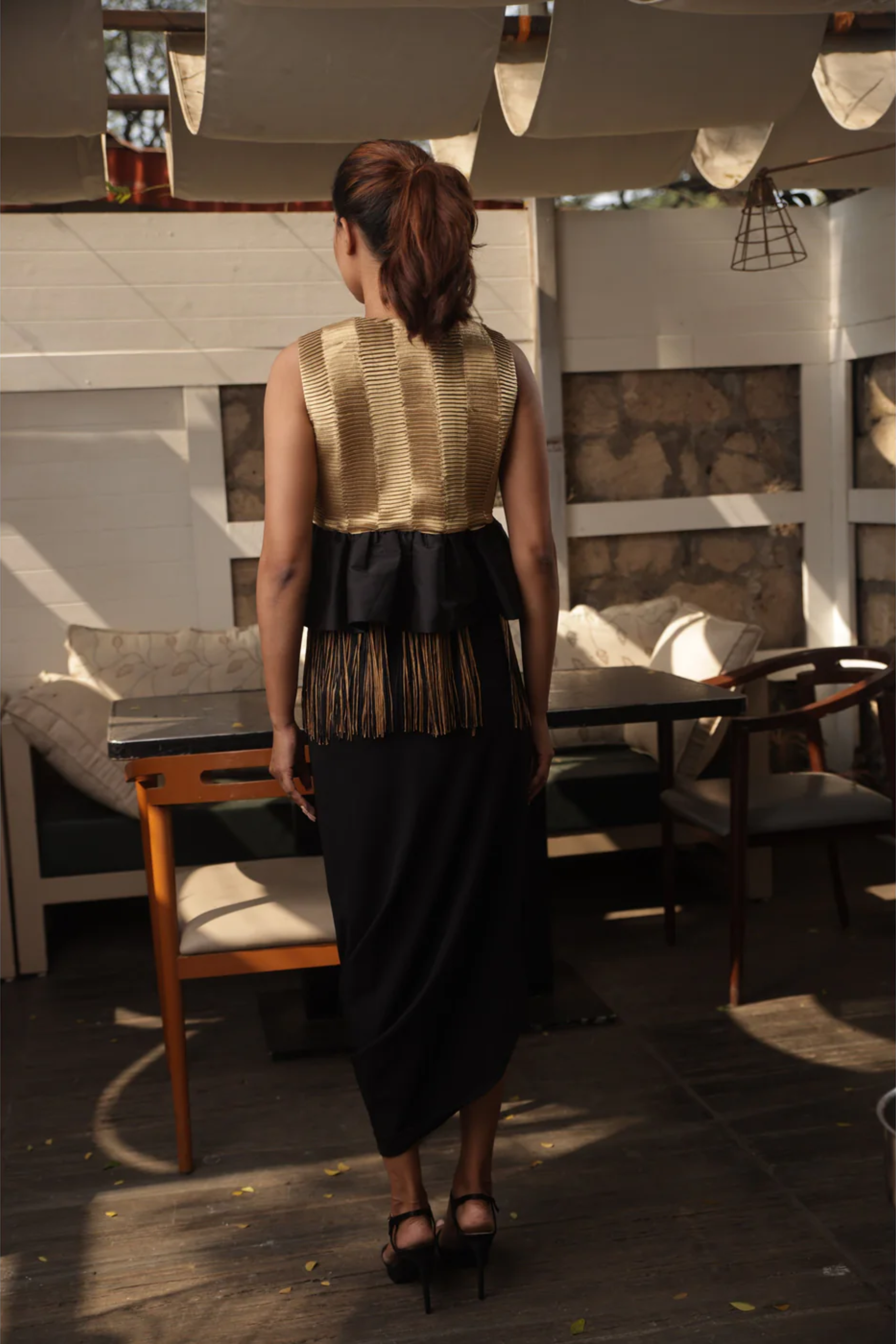 Gold tissue bolero jacket top with black and gold tassels.