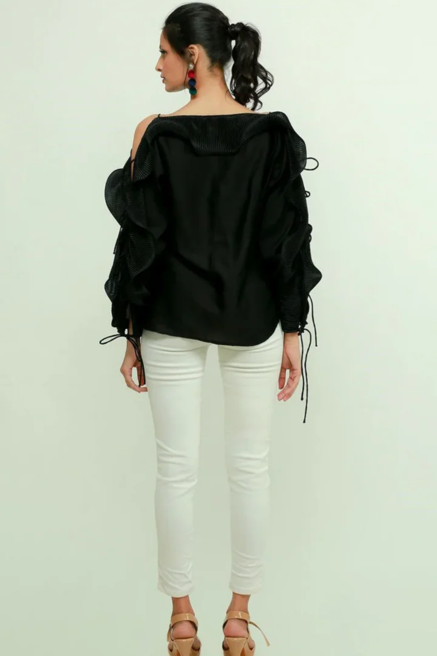 Black silk off-shoulder top features a pleated frill running across the sleeves.