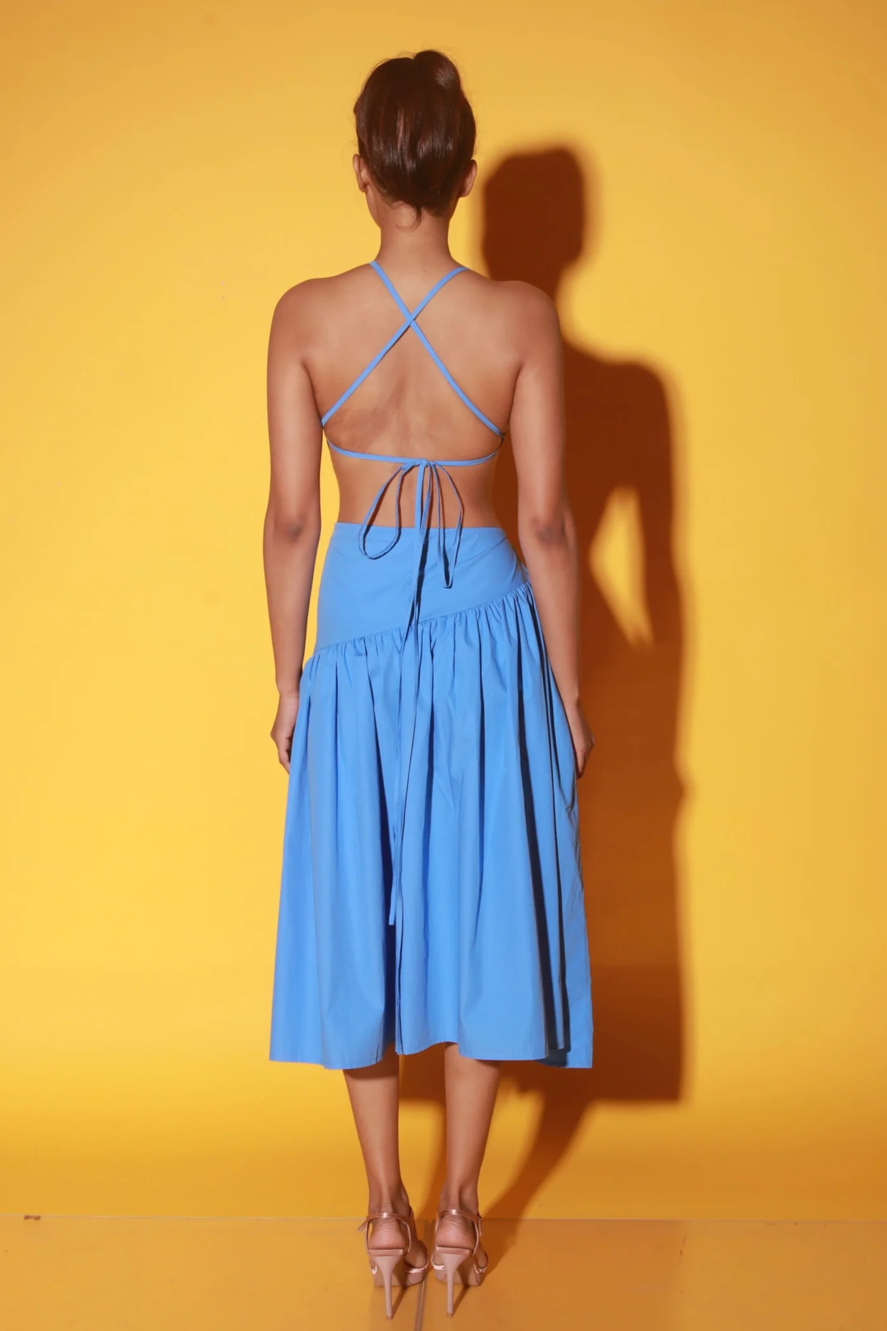 Slate blue midi dress with spaghetti straps and ruching detailing on the waist.