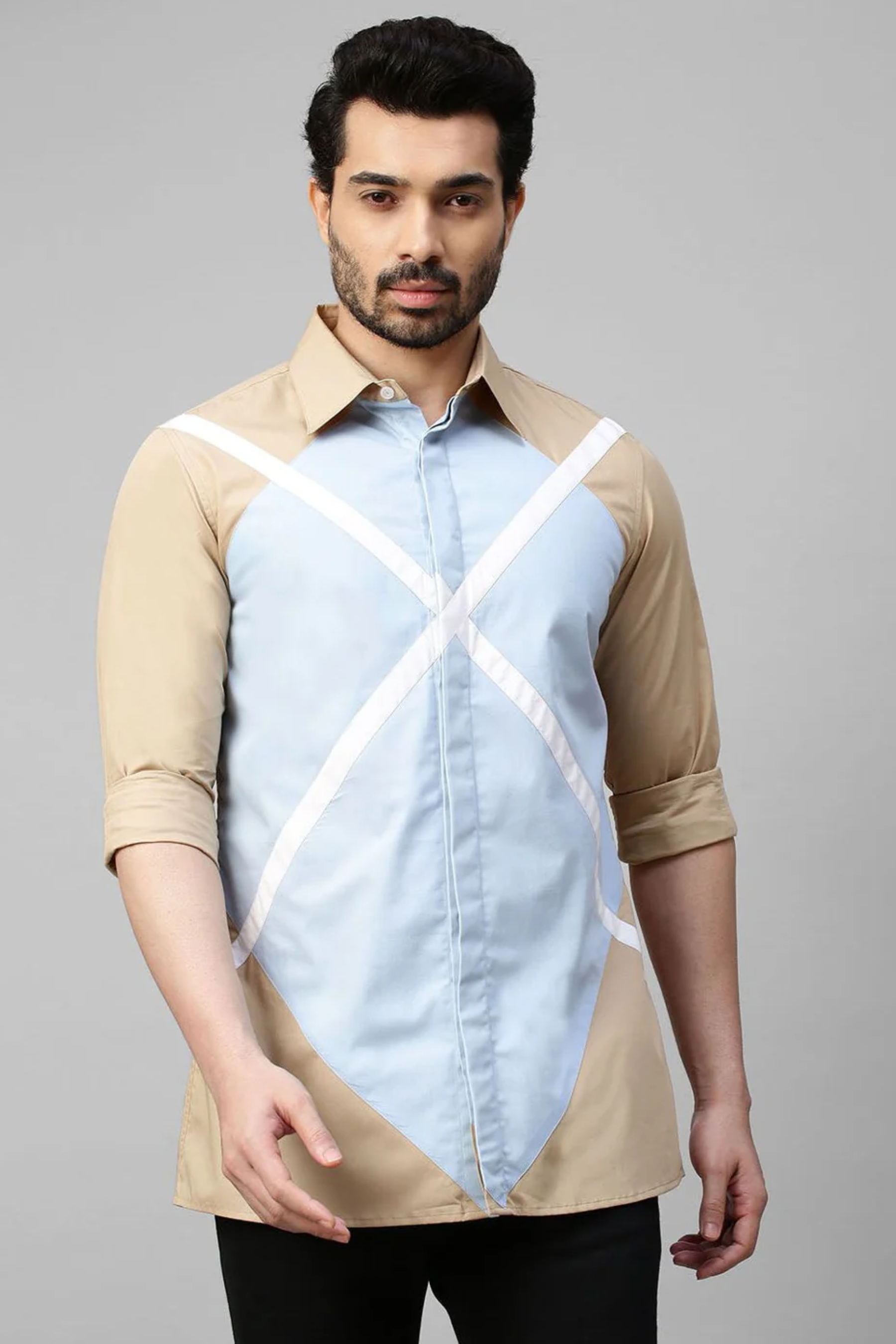 Beige shirt with light blue and white patchwork detailing.