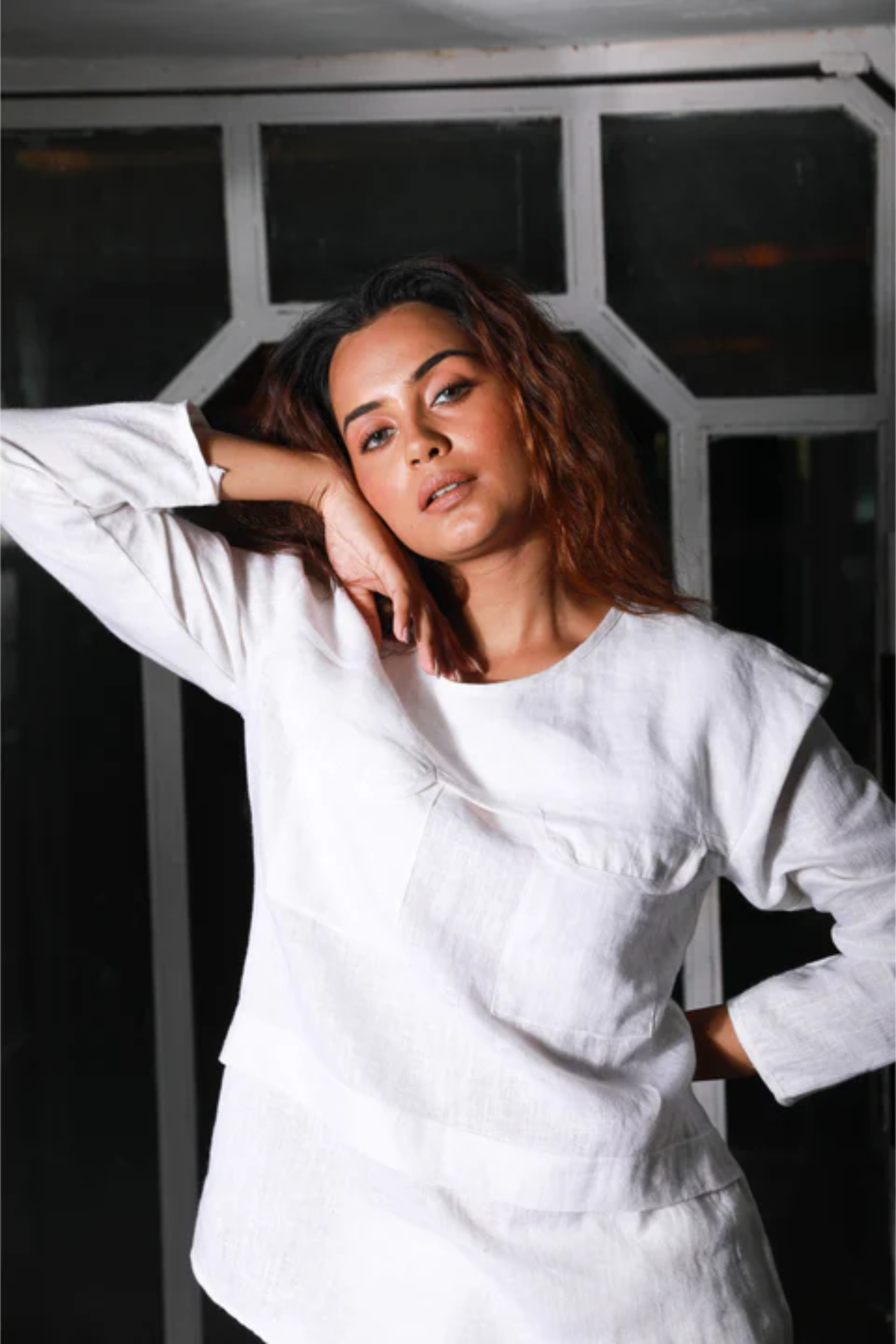 White linen co-ord set features a top with two pocket detailing and matching straight pants.