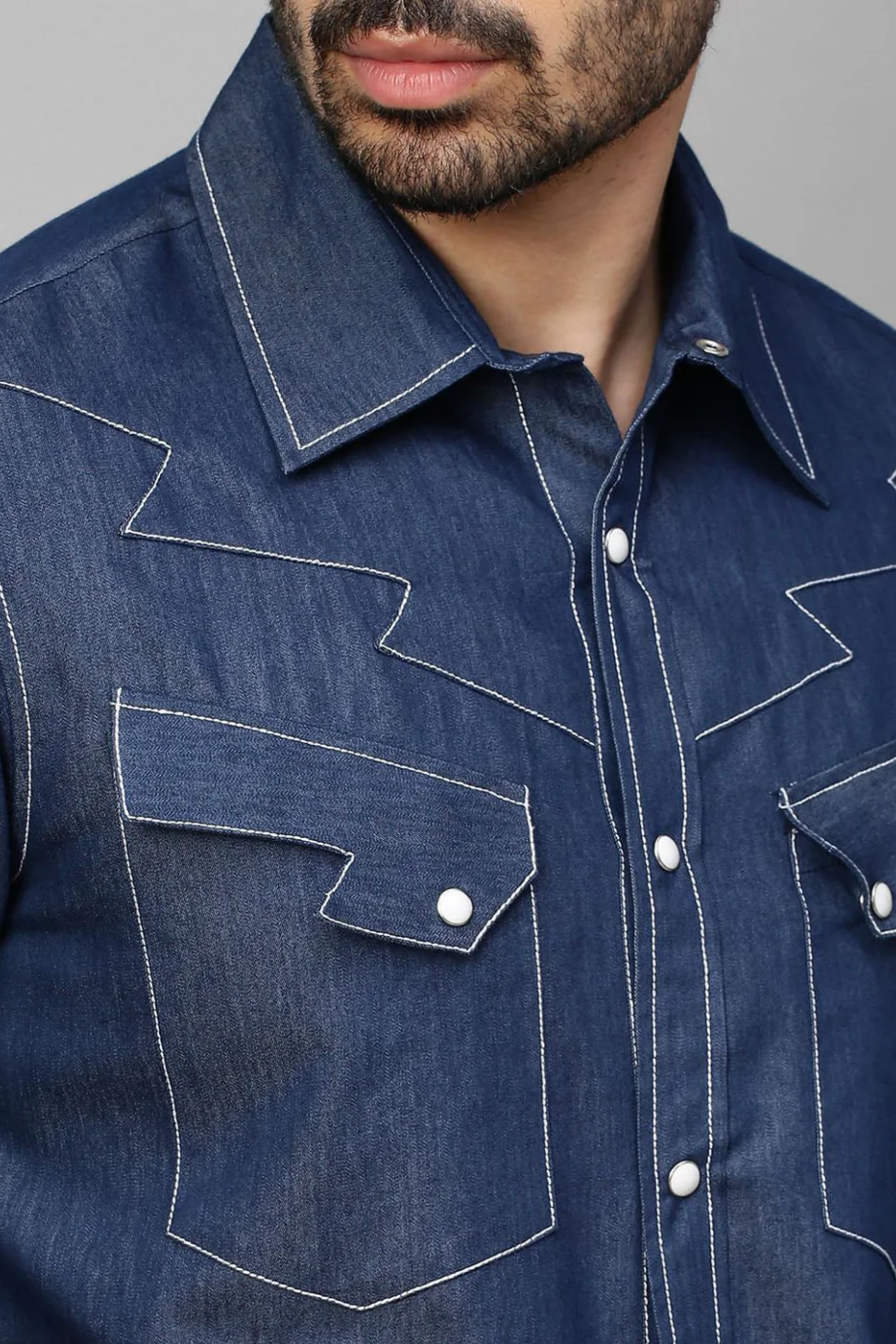 Denim shirt with contrast stitching feature.