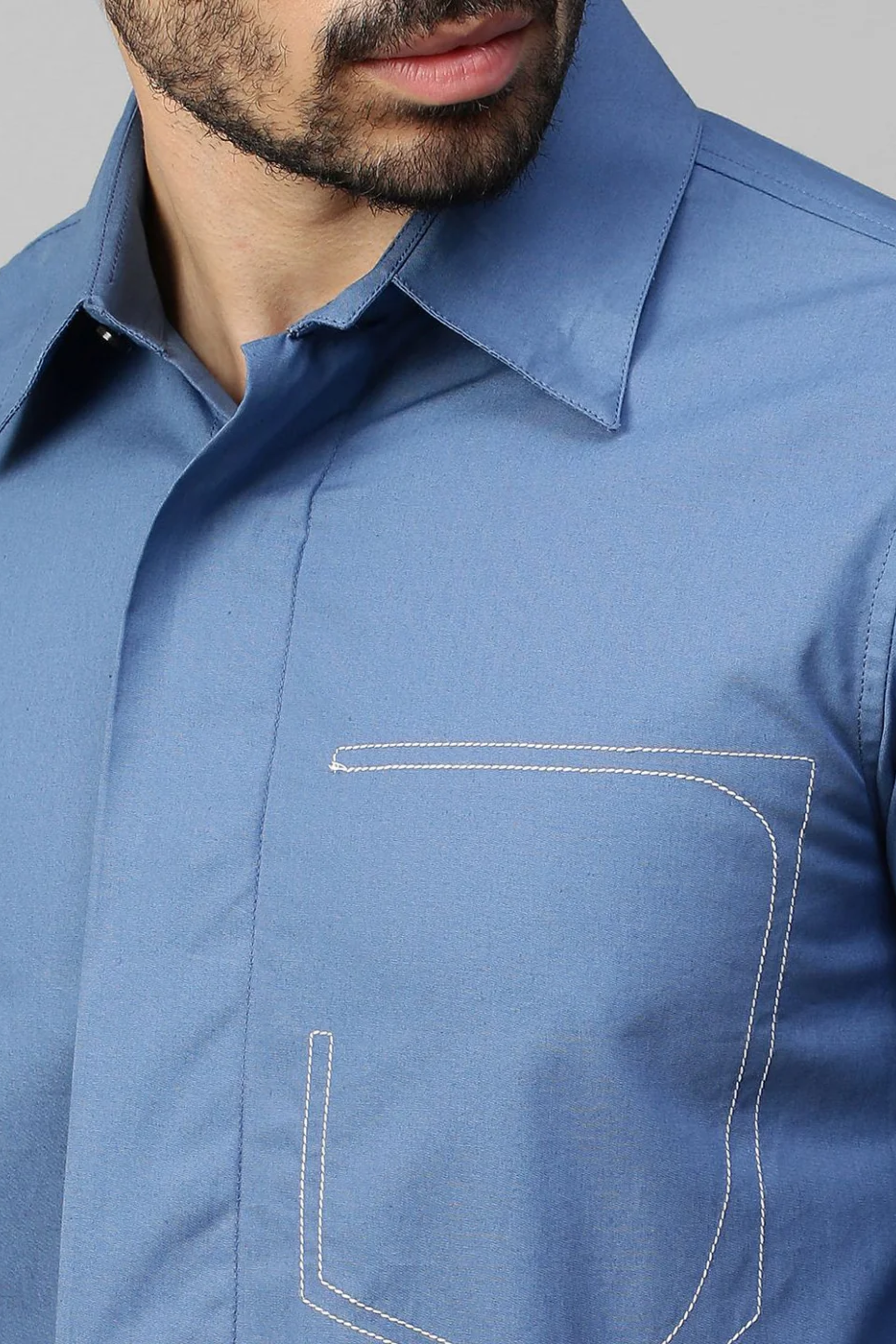 Slate blue classic shirt with white stitching pocket feature.