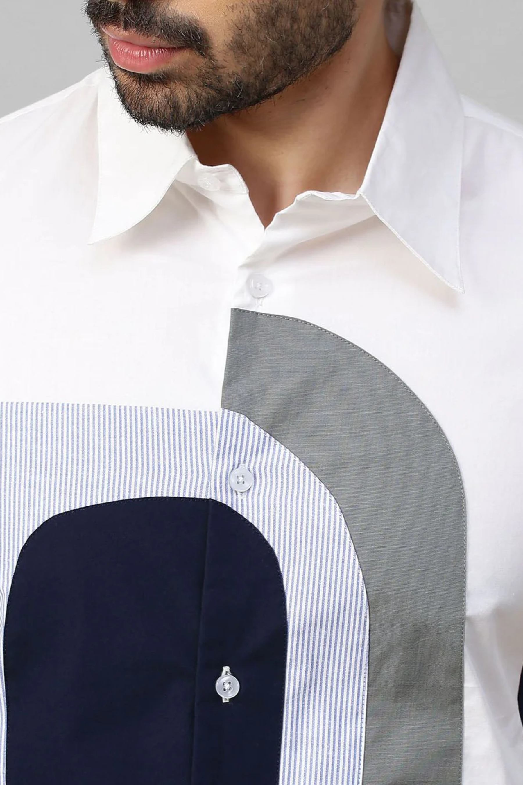 White shirt with color block patch detailing.
