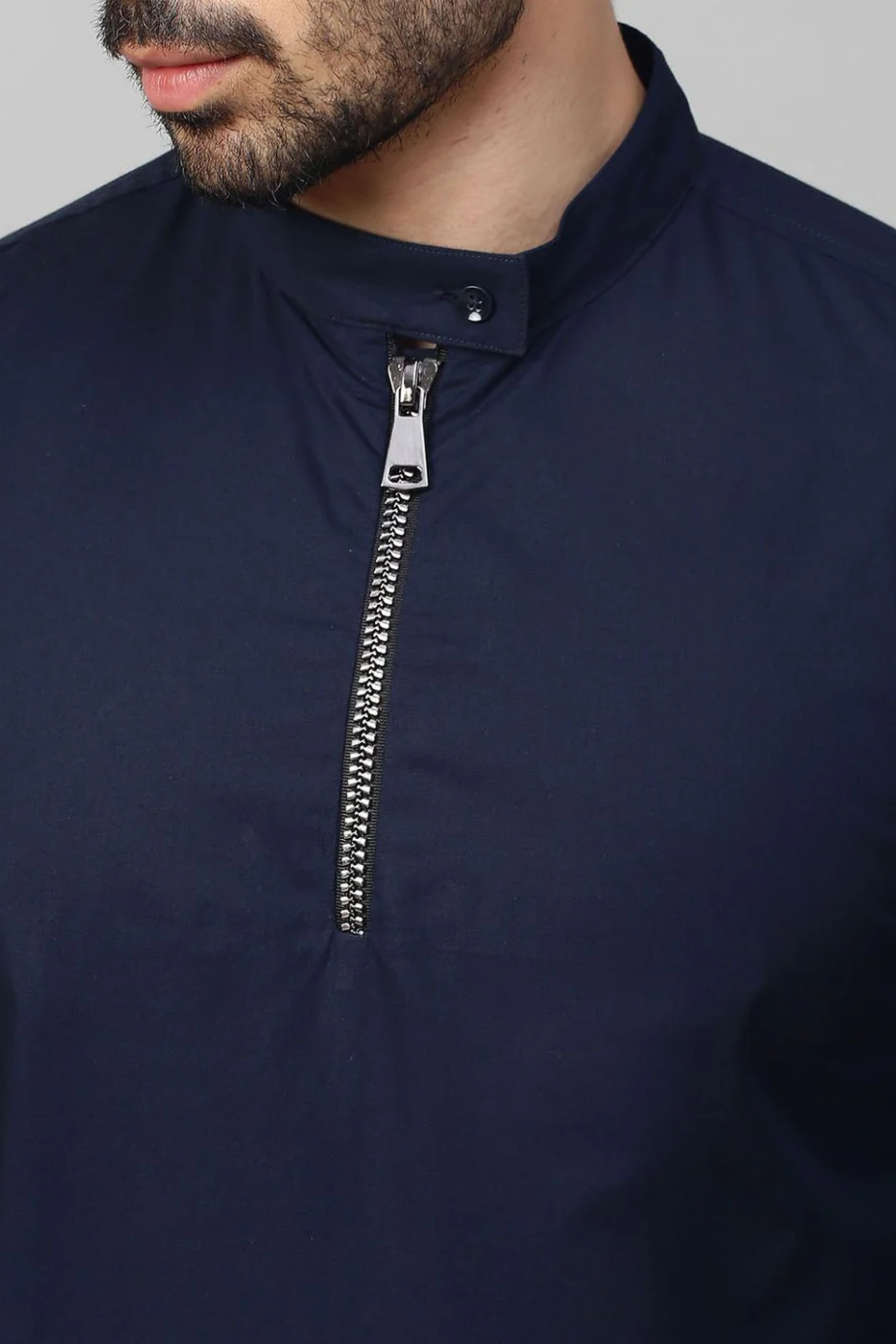 Blue mandarin collar shirt with half zipper detailing.