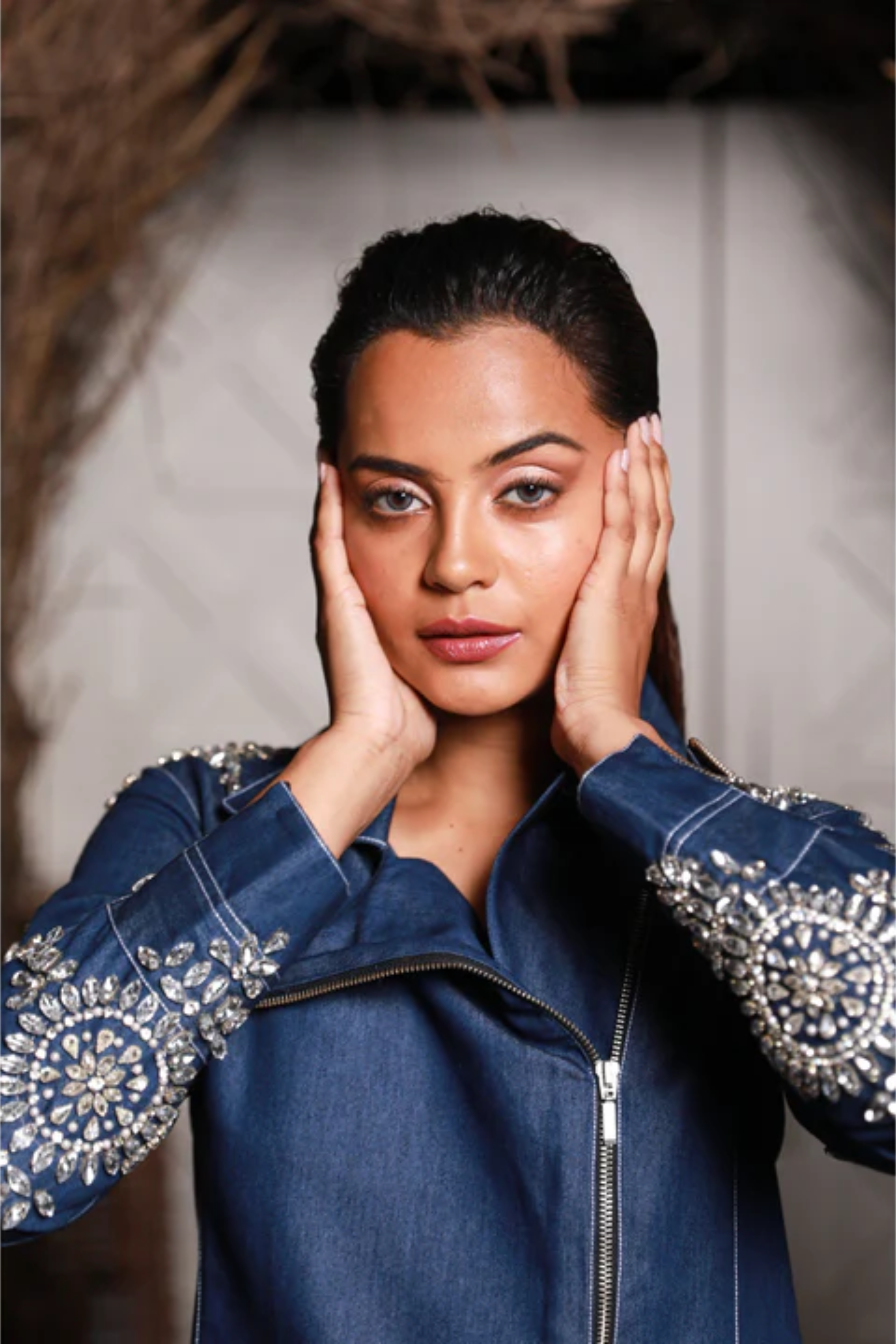 Denim zippered jacket top doubles up as a short dress and features white rhinestone embroidery.