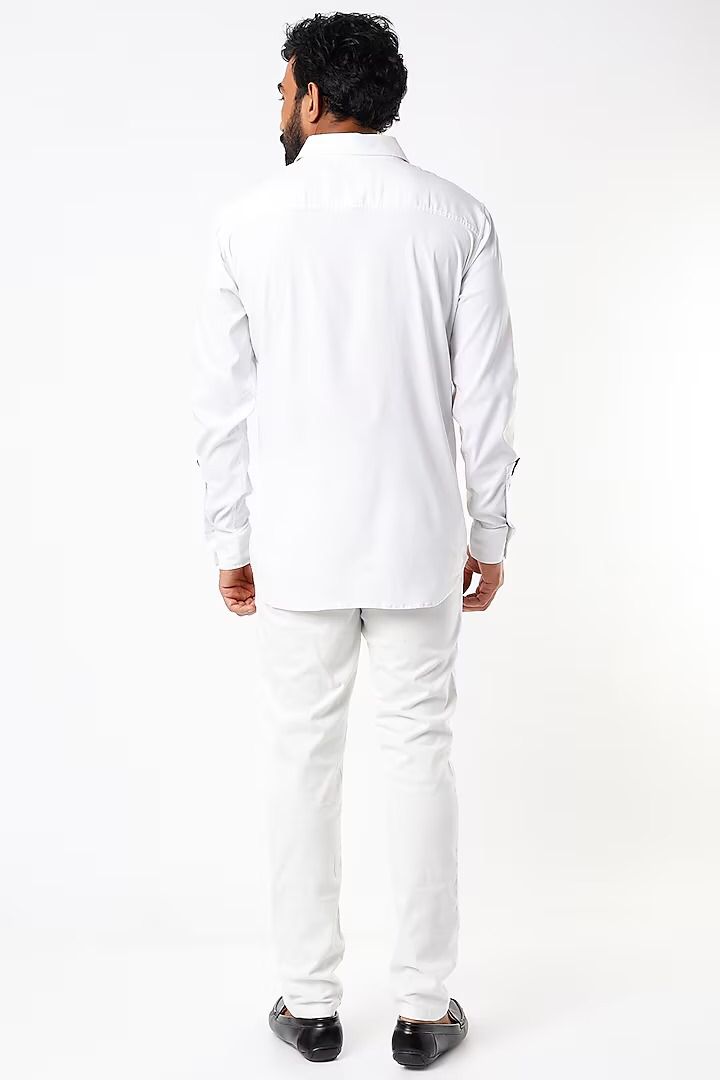 White shirt with black detailing below the collar, on placket, pocket and cuff slit
