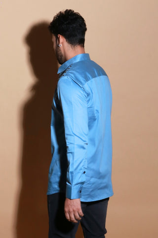 Slate blue classic shirt with rivet feature around shoulder.