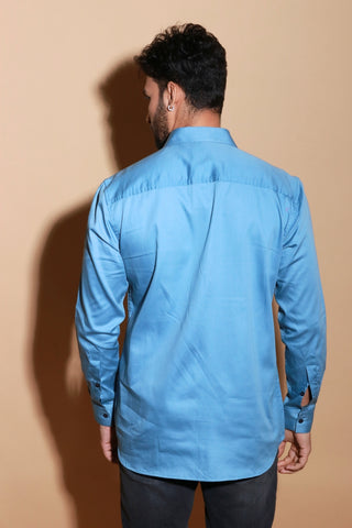 Slate blue classic shirt with rivet feature around shoulder.