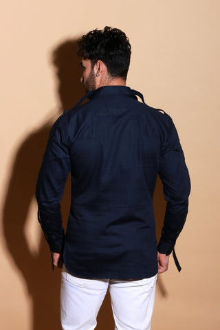 Blue shirt with pintucks and adjustable strap feature on sleeves.