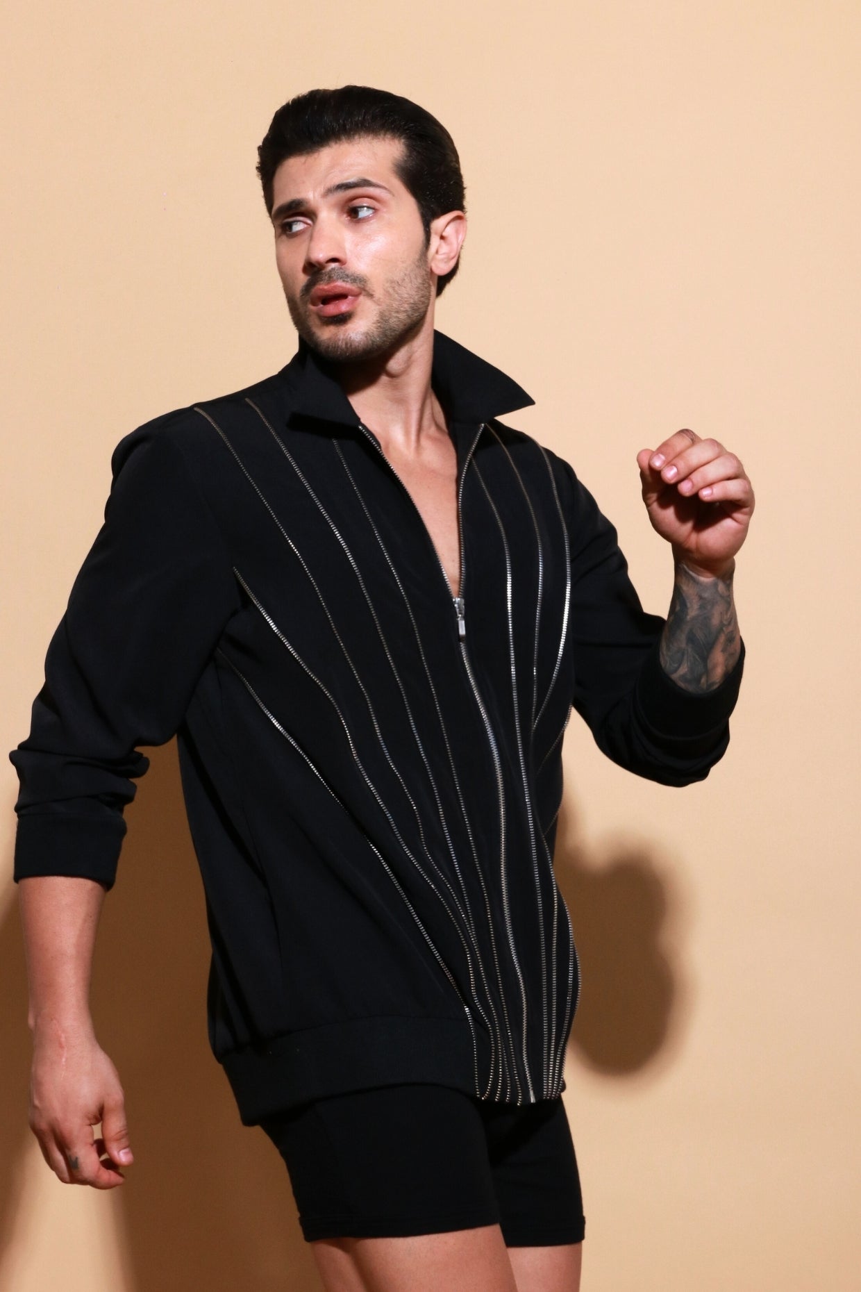 Black bomber jacket with diagonal zipper accents.