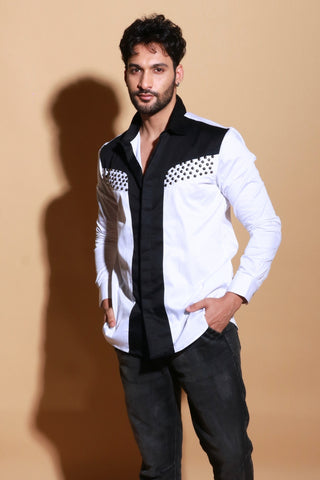 White shirt with black panel and stud detailing.