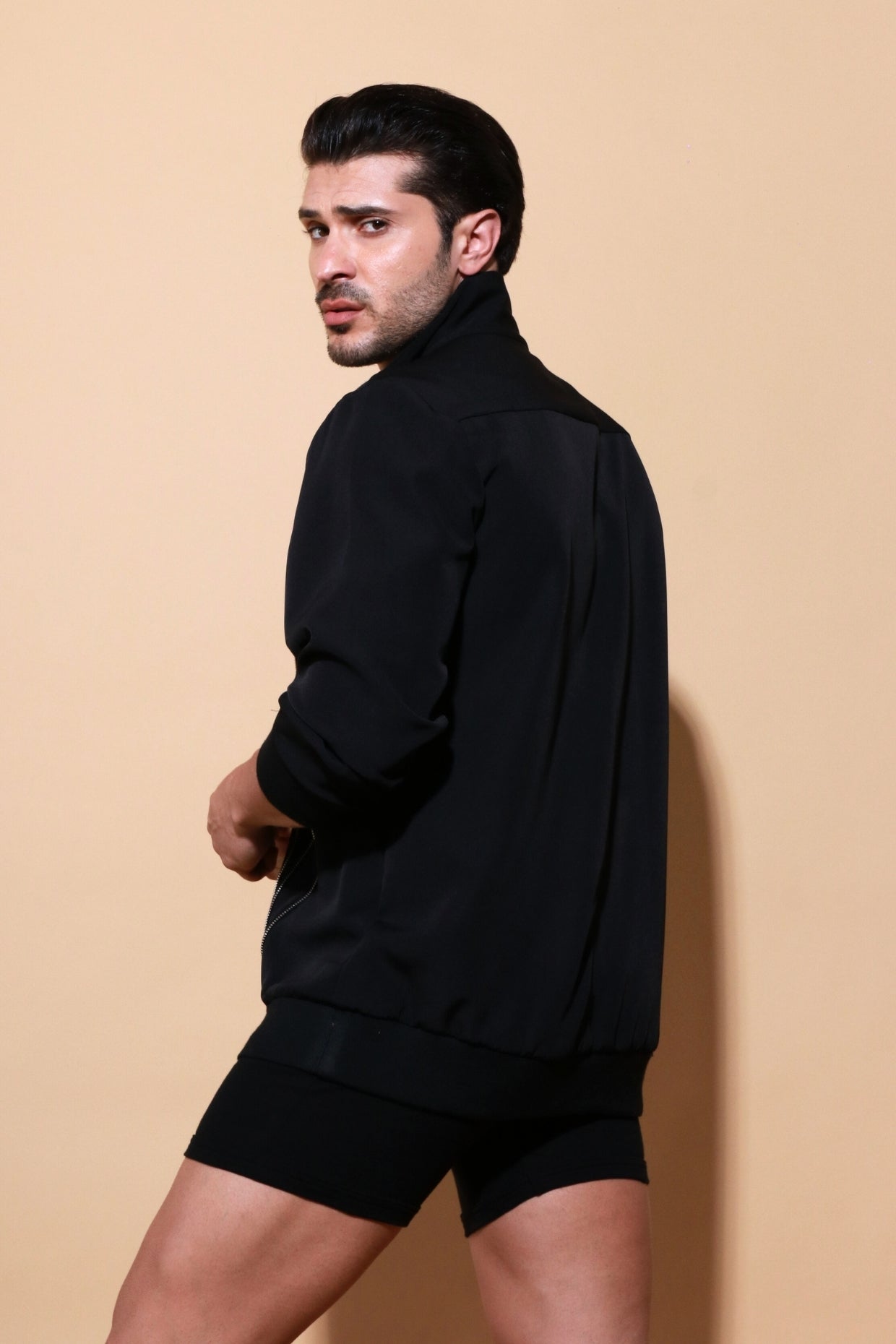 Black bomber jacket with diagonal zipper accents.