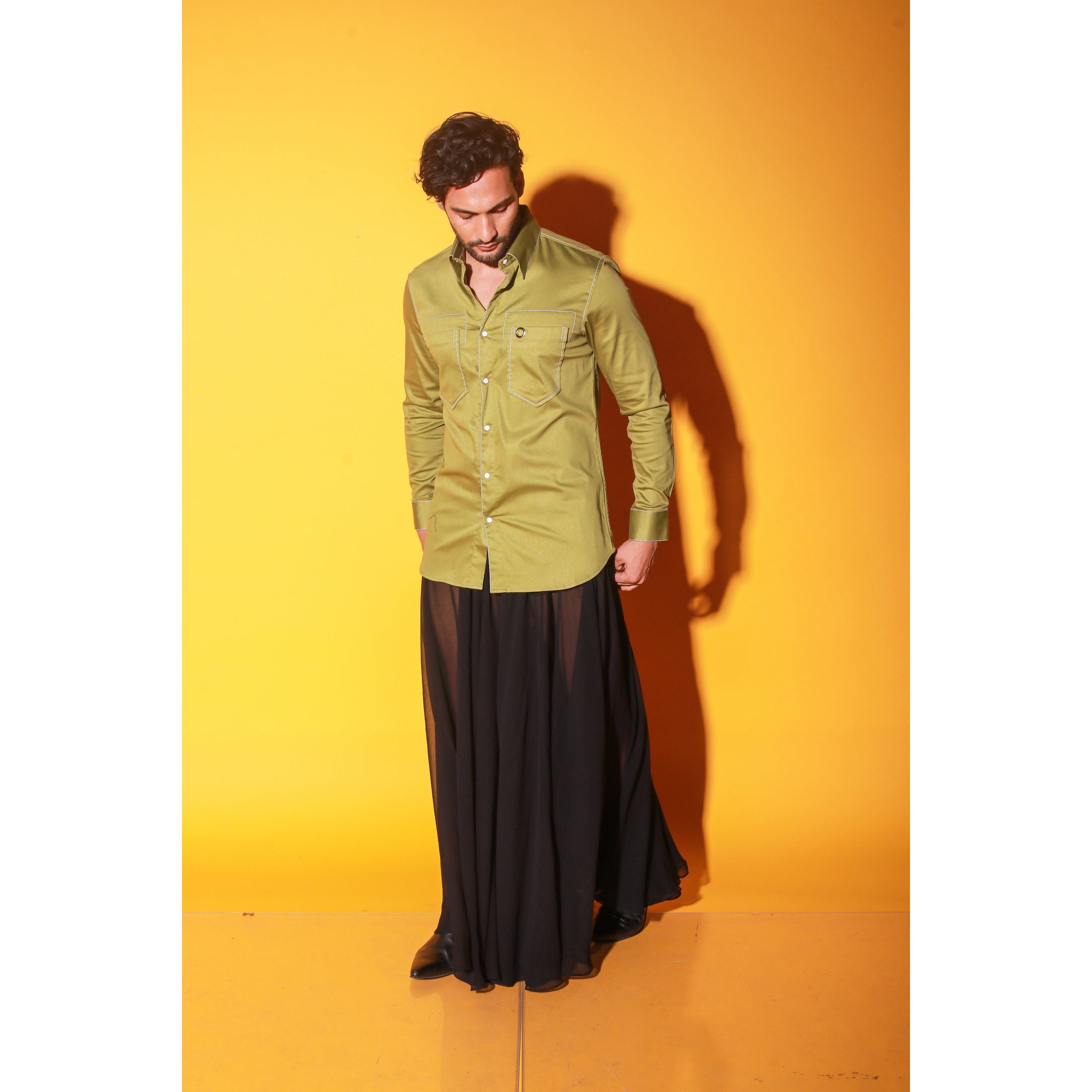 Green shirt with white stitching feature