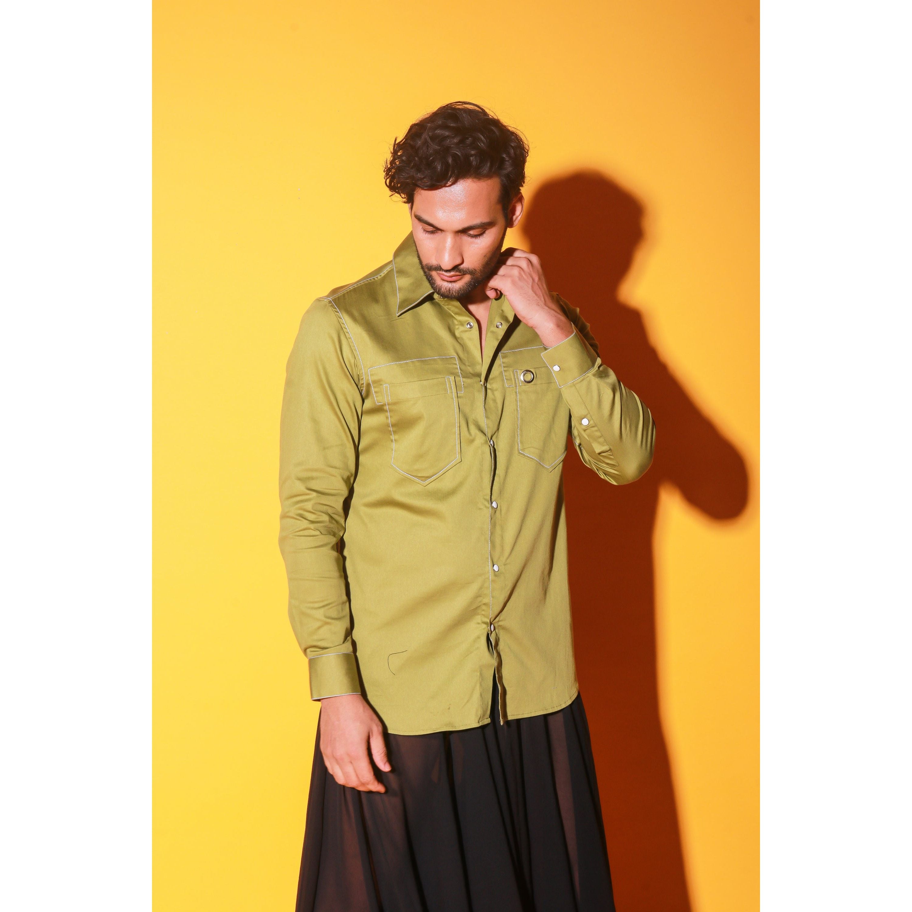 Green shirt with white stitching feature