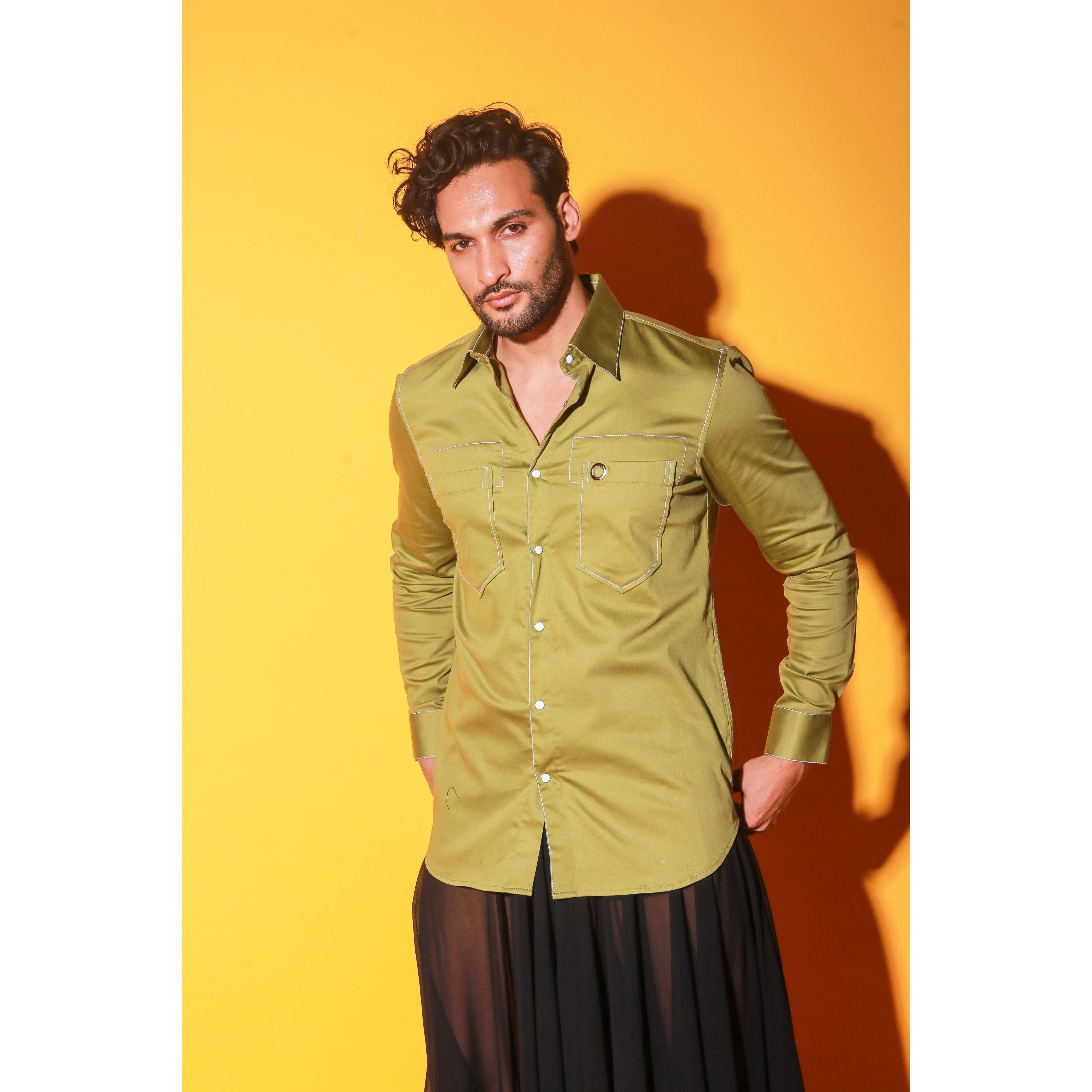 Green shirt with white stitching feature