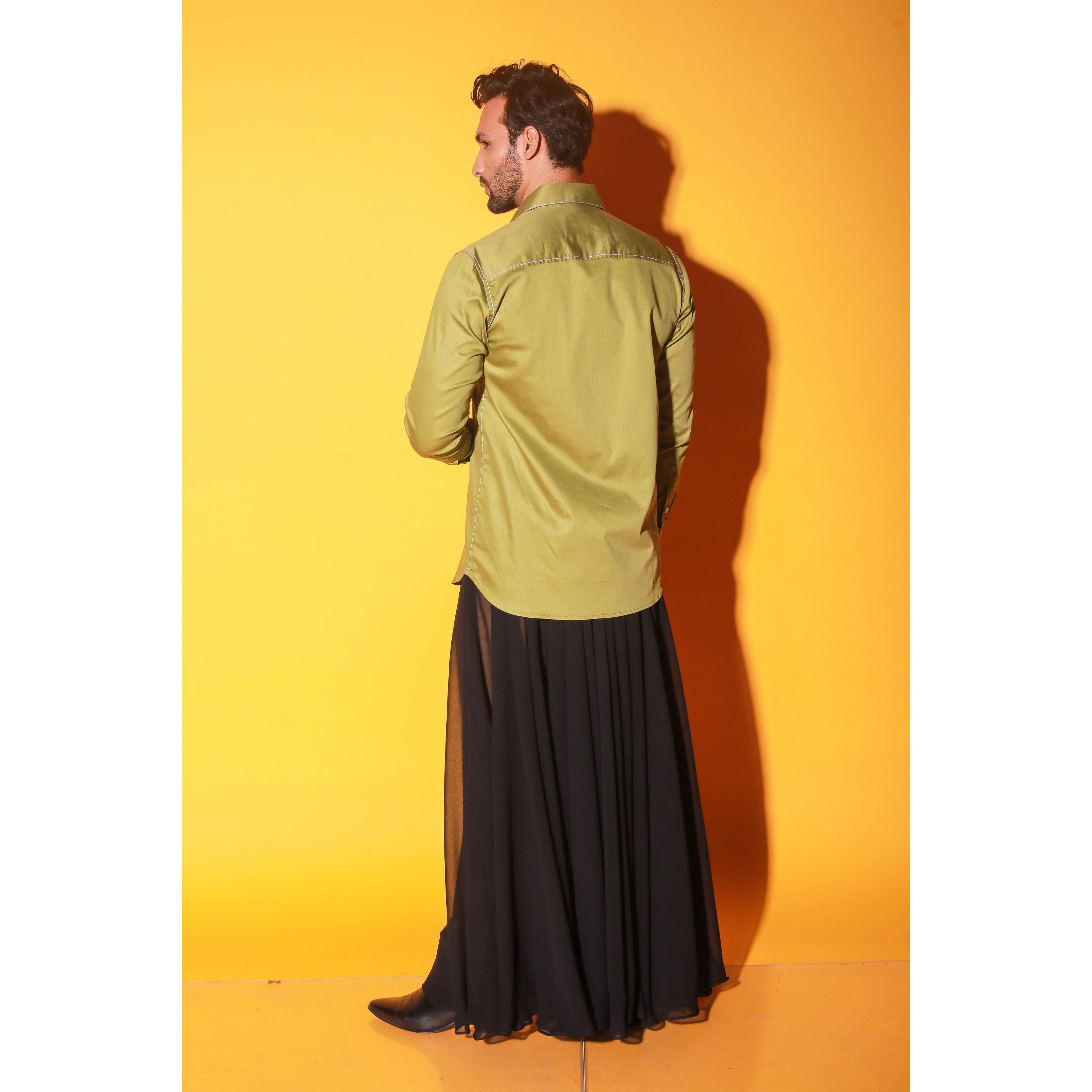 Green shirt with white stitching feature