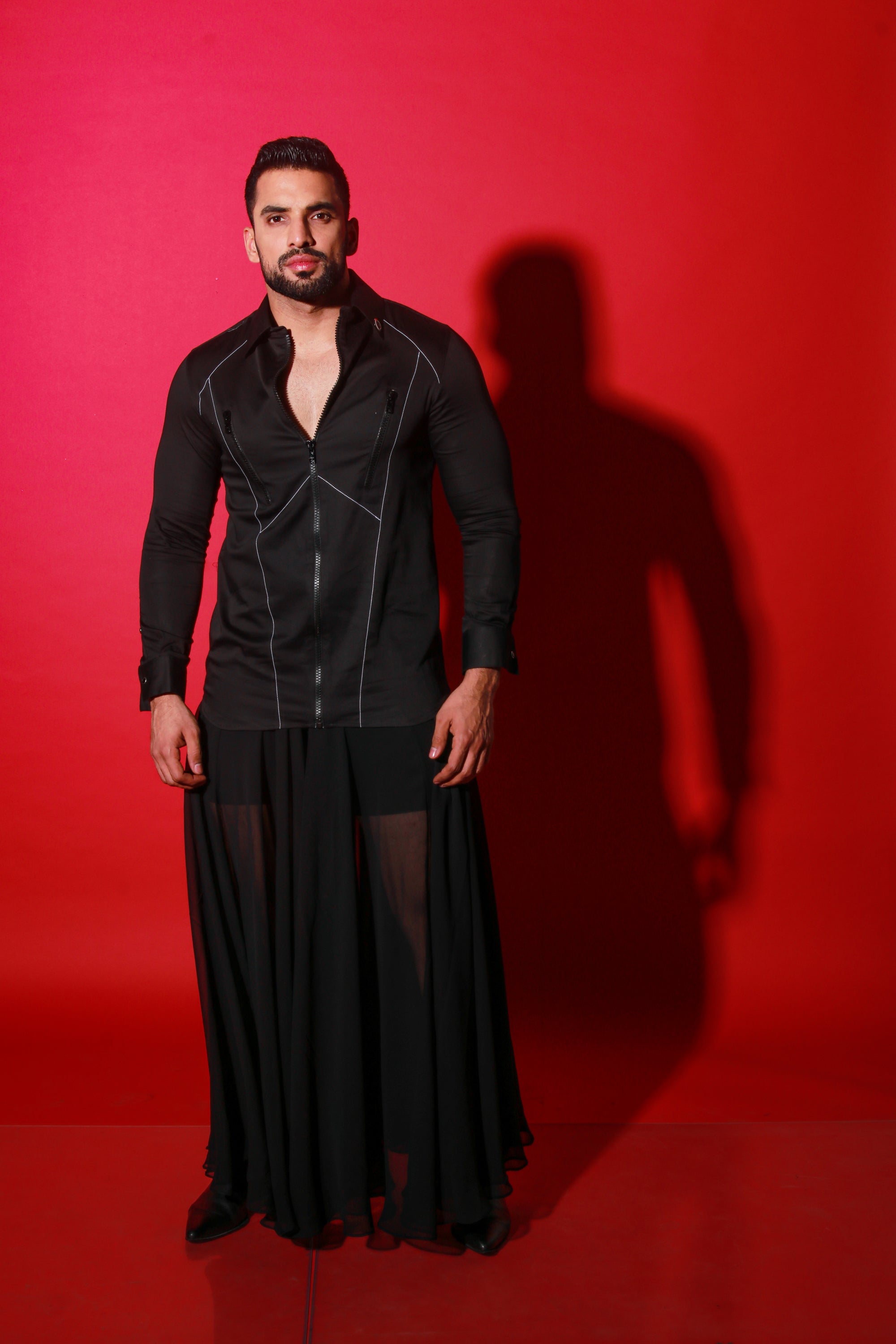 Black shirt with black zipper detailing and pockets.